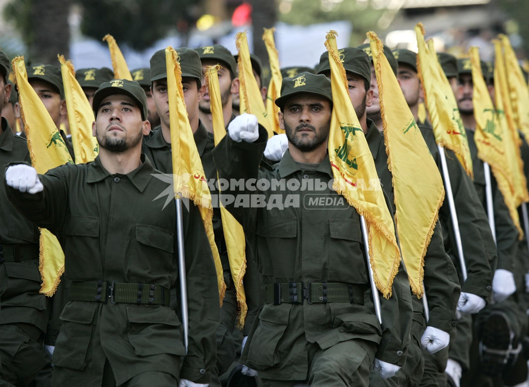 Хезболла
Members of the Hezbollah guerilla group hold yellow flags of the Hezbollah as they parade during the annual rally to mark Al-Quds Day, Jerusalem Day, in the southern suburbs of Beirut, Lebanon, Friday, Oct. 28, 2005.  Sheik Hassan Nasrallah, leader of Lebanon\\\'s Hezbollah guerrillas,  pledged Friday to support  Syria, and also lashed out at U.N. efforts aimed at disarming his anti-Israel guerrillas, saying the international community aims to serve the interests of America and Israel. (AP Photo/Hussein Malla)