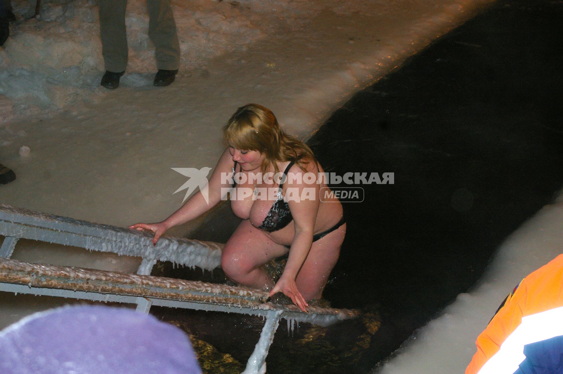 Девушка купается в проруби на Крещение, 19 января 2009 года, Саратов. Крещенские морозы, прорубь, купальник, грудь, девушка, снег, ледяная вода, обморожение, обряд, святая вода, купель.