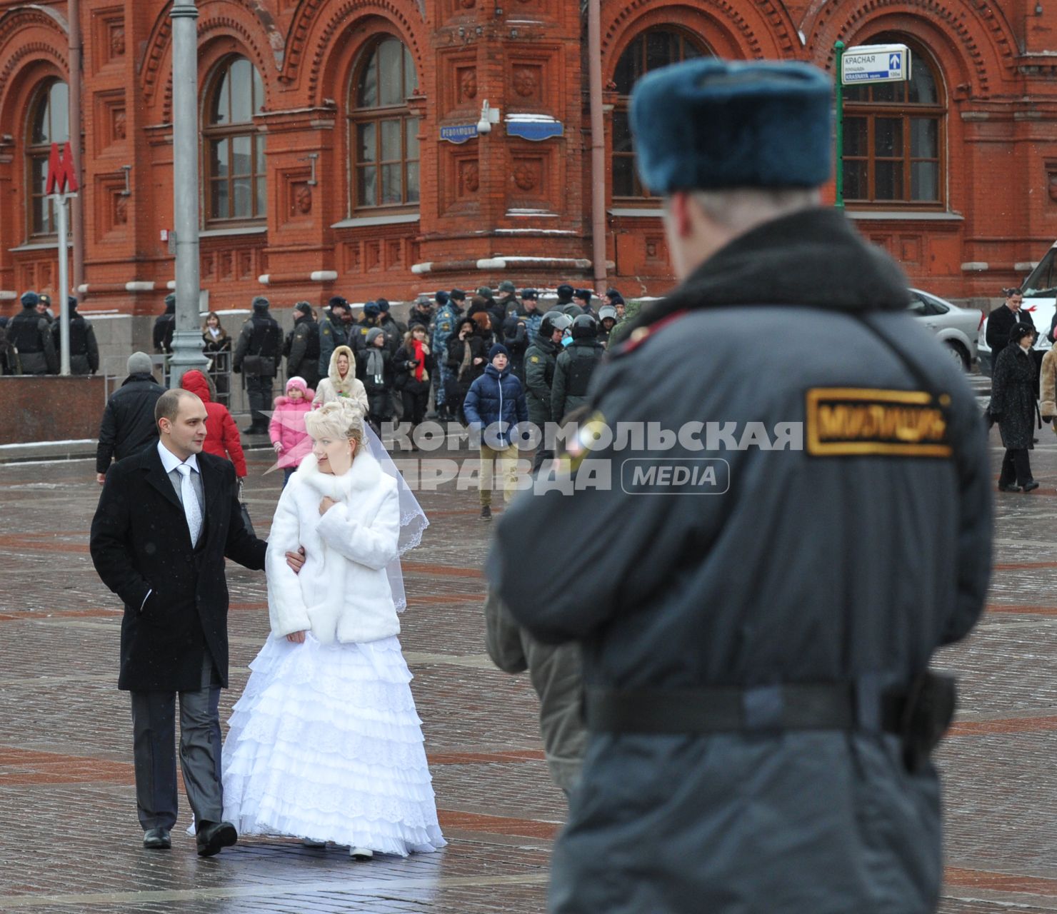 Россия. Москва. 15 января 2011. Манежная площадь, милиция, милиционер. Молодожены,  жених невеста.