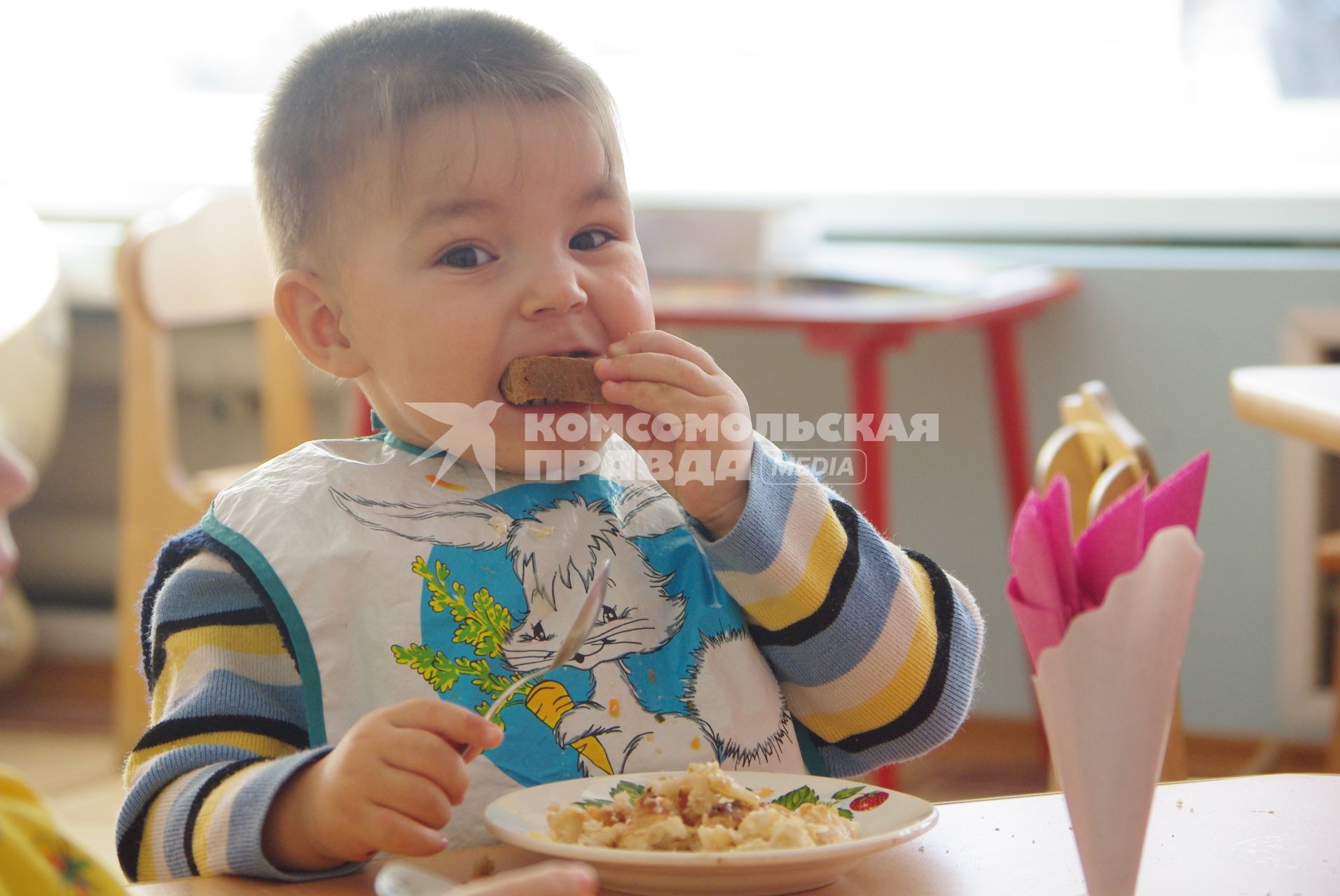 Мальчик с аппетитом ест кашу и хлеб в детском саду , Саратов, 3 февраля 2011 года. Детский сад, детсад, дети, еда, хлеб, обед, питание, ребенок,каша, котлета