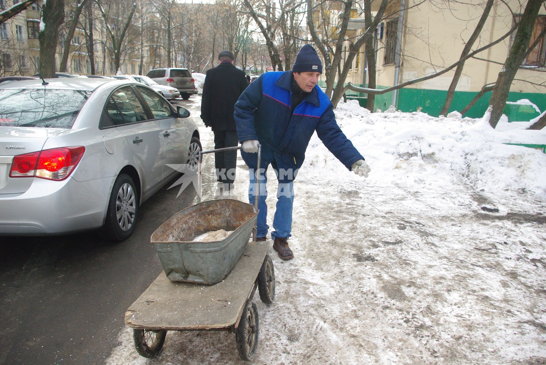 Обледеневшие дороги и дворы города посыпают реагентом и солью, Москва, 27 февраля 2011 года.