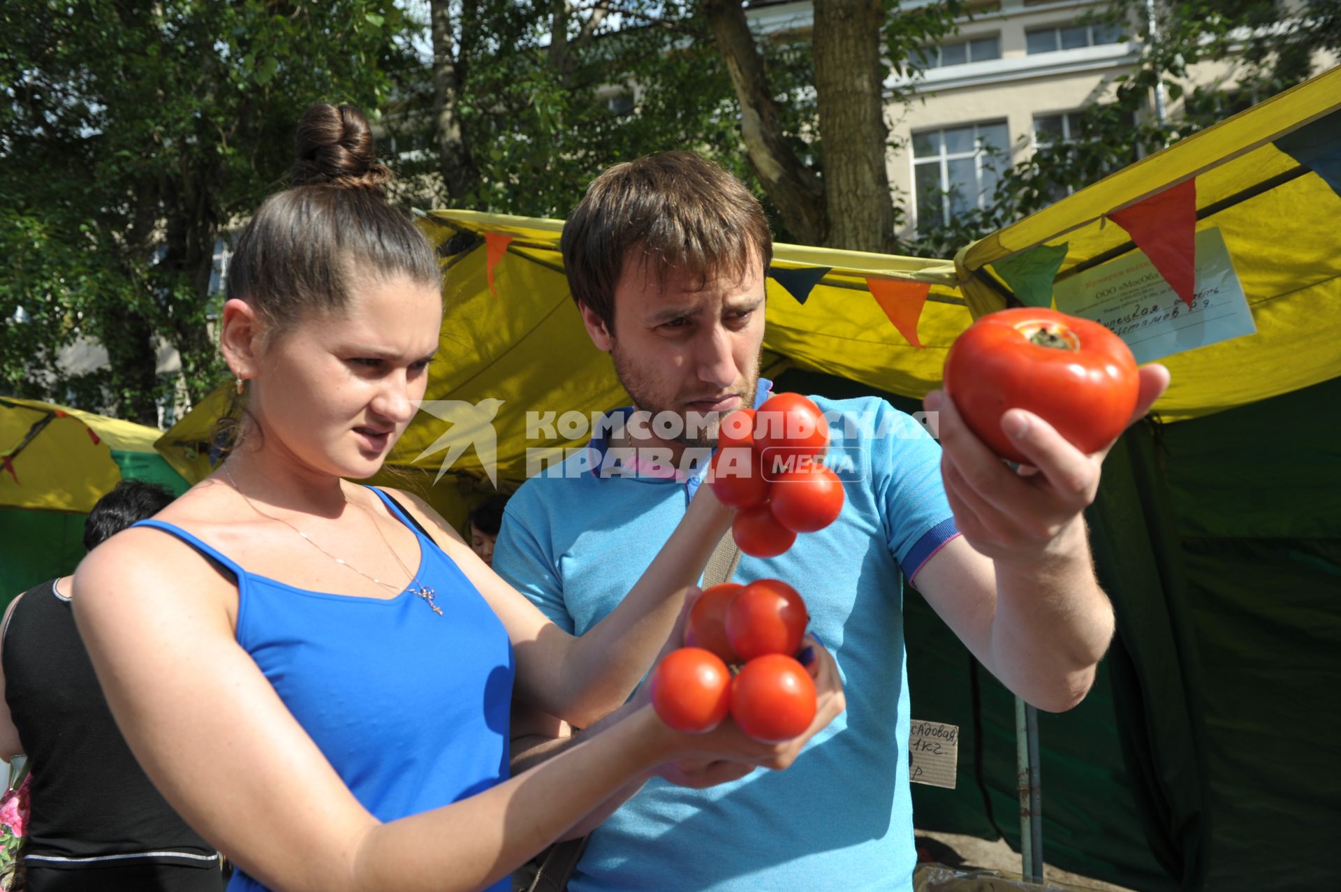 Молодой человек и девушка с помидорами в руках,  Москва,10 июня 2011 года