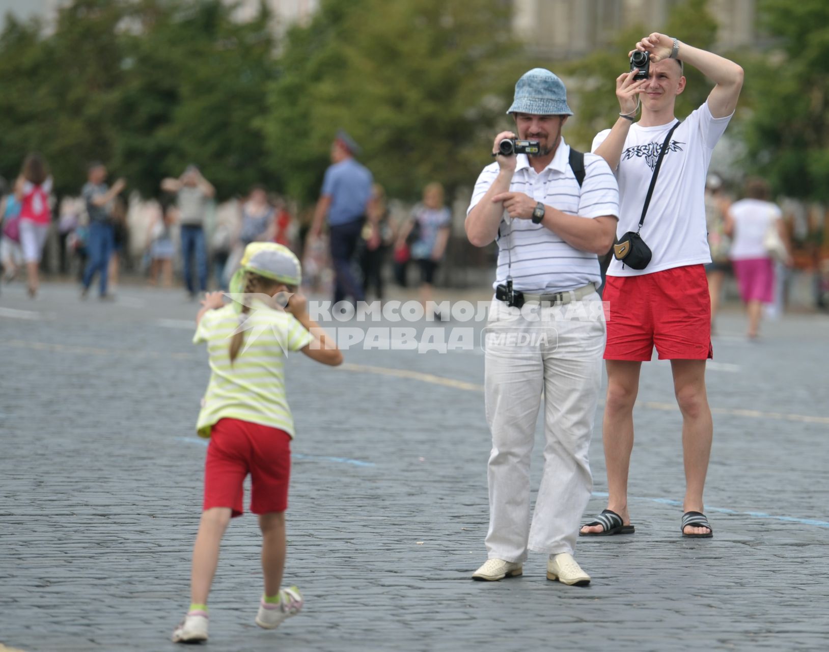 Туристы фотографируют на Красной площади, Москва, 14 июля 2011 года.