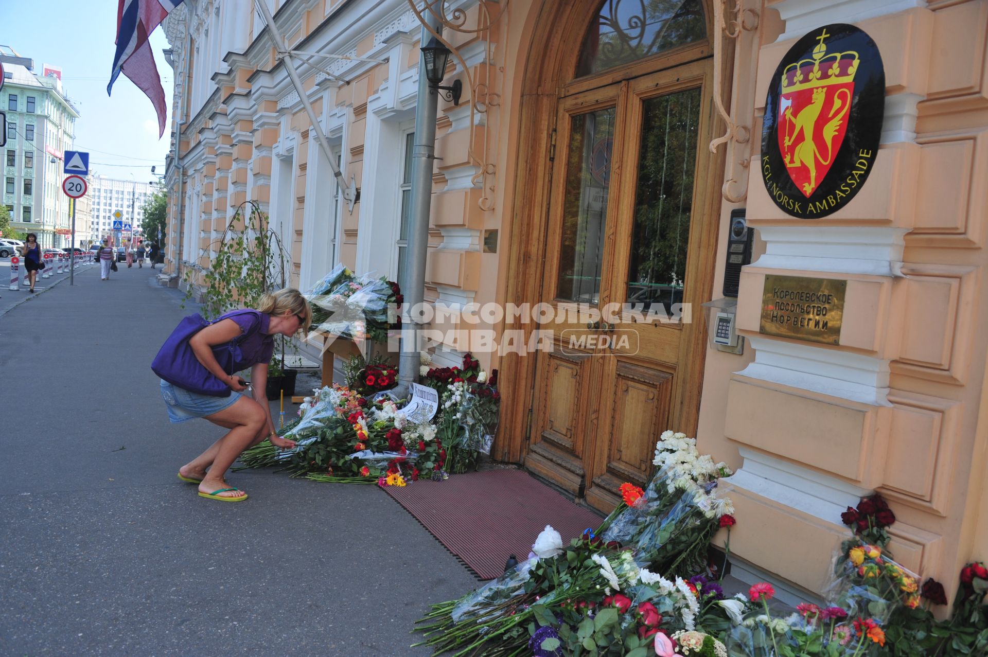 Люди приносят цветы к посольству Норвегии  в память о погибших в двойном теракте в Осло. Москва.  24 июля 2011 года.