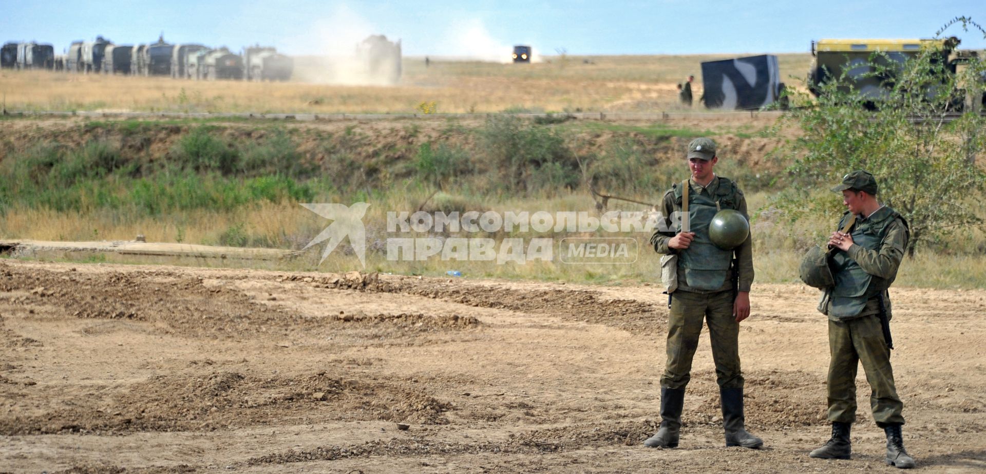 На снимке: Содаты стоят на поле, мимо проходит военная техника. Учения ЦЕНТР-2011 на полигоне КАПУСТИН ЯР_. 20 сентября 2011 года.