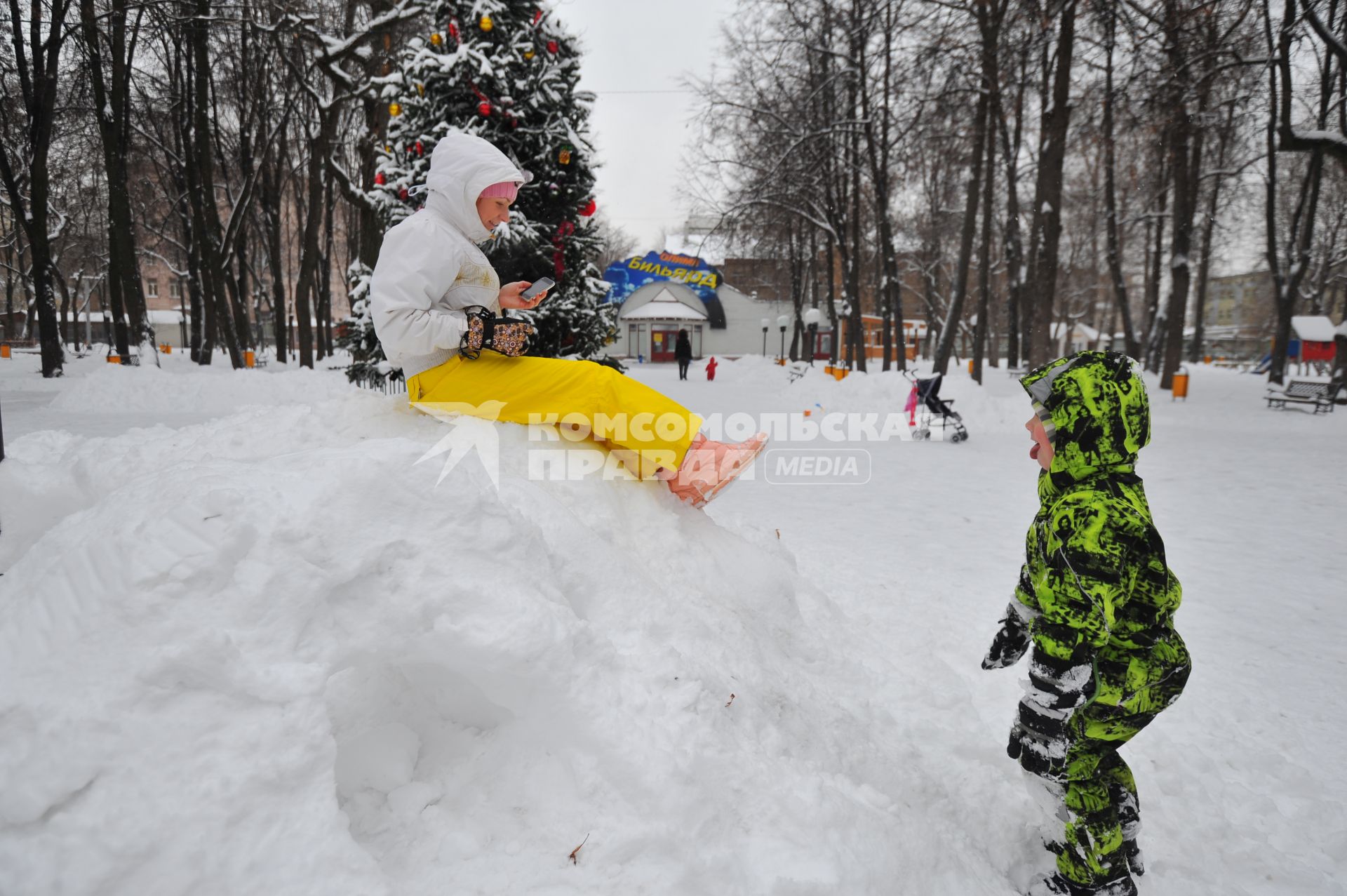 Прогулка зимой. Женщина сидит на сугробе.  Москва. 21 декабря  2011 года.