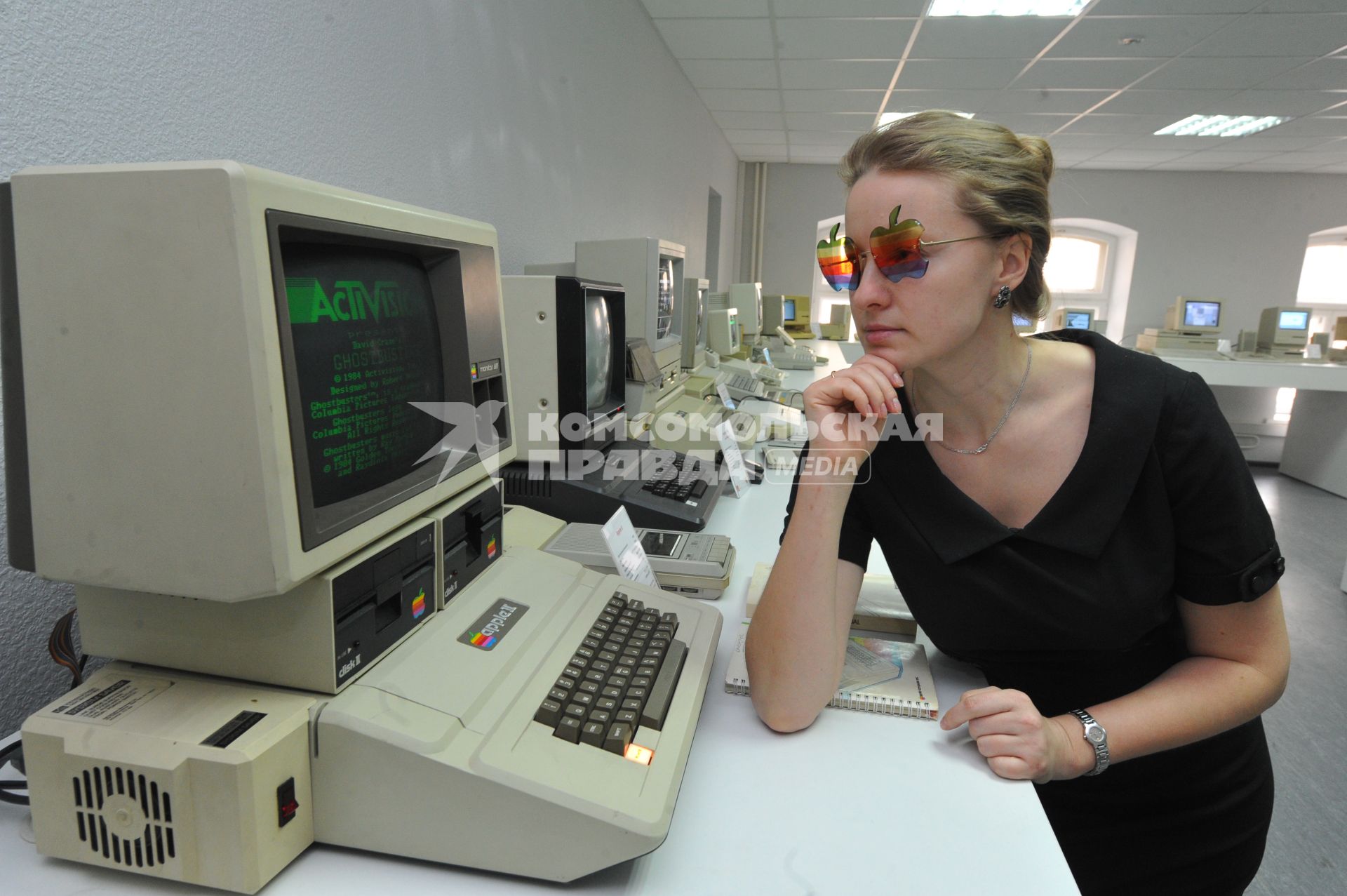 В Москве открылся музей Apple. На снимке: девушка в раритетных очках Apple рядом с компьютером Apple II.