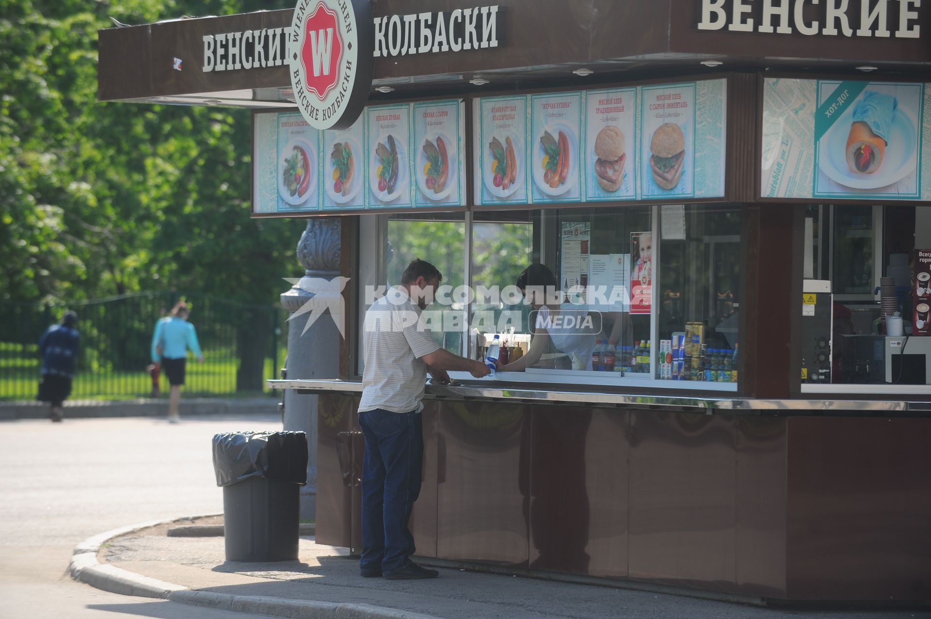 Мужчина у ларька с `Венскими колбасками`