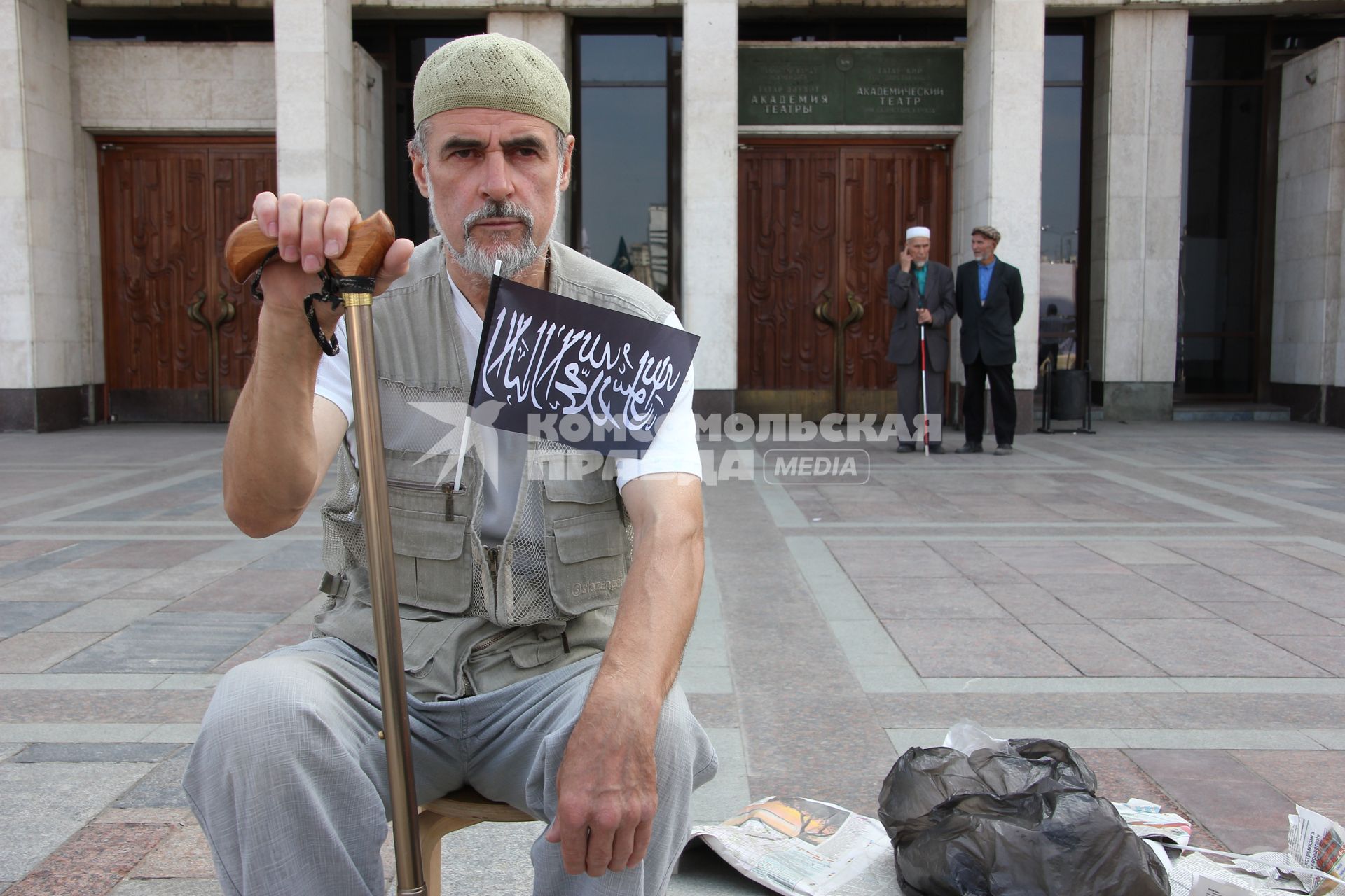 Митинг мусульман против произвола полиции. Площадь театра Камала. Казань. На снимке: Старик с палкой сидит, держит флажок с лозунгами.