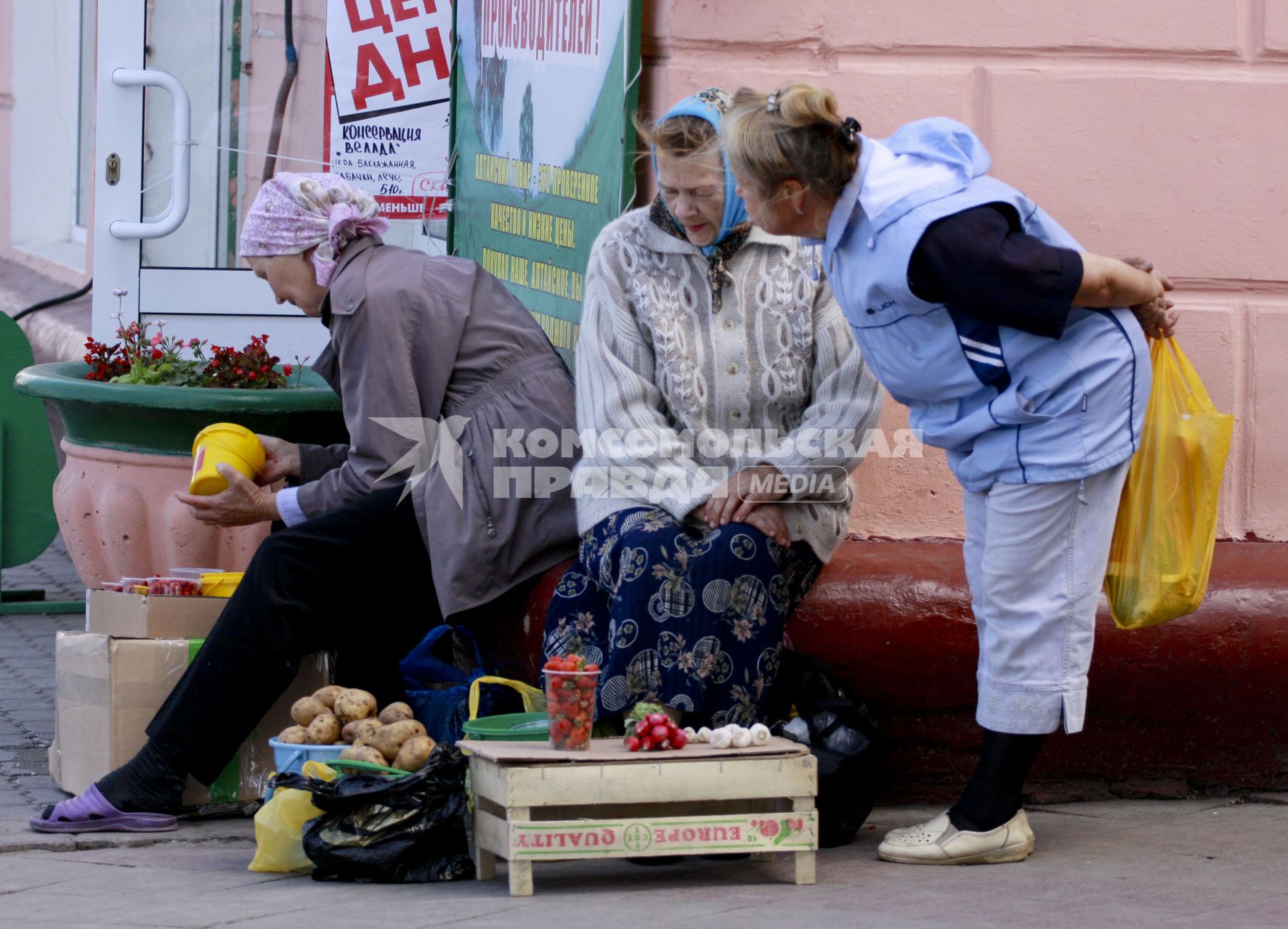 Бабушки продают ягоды и картофель.