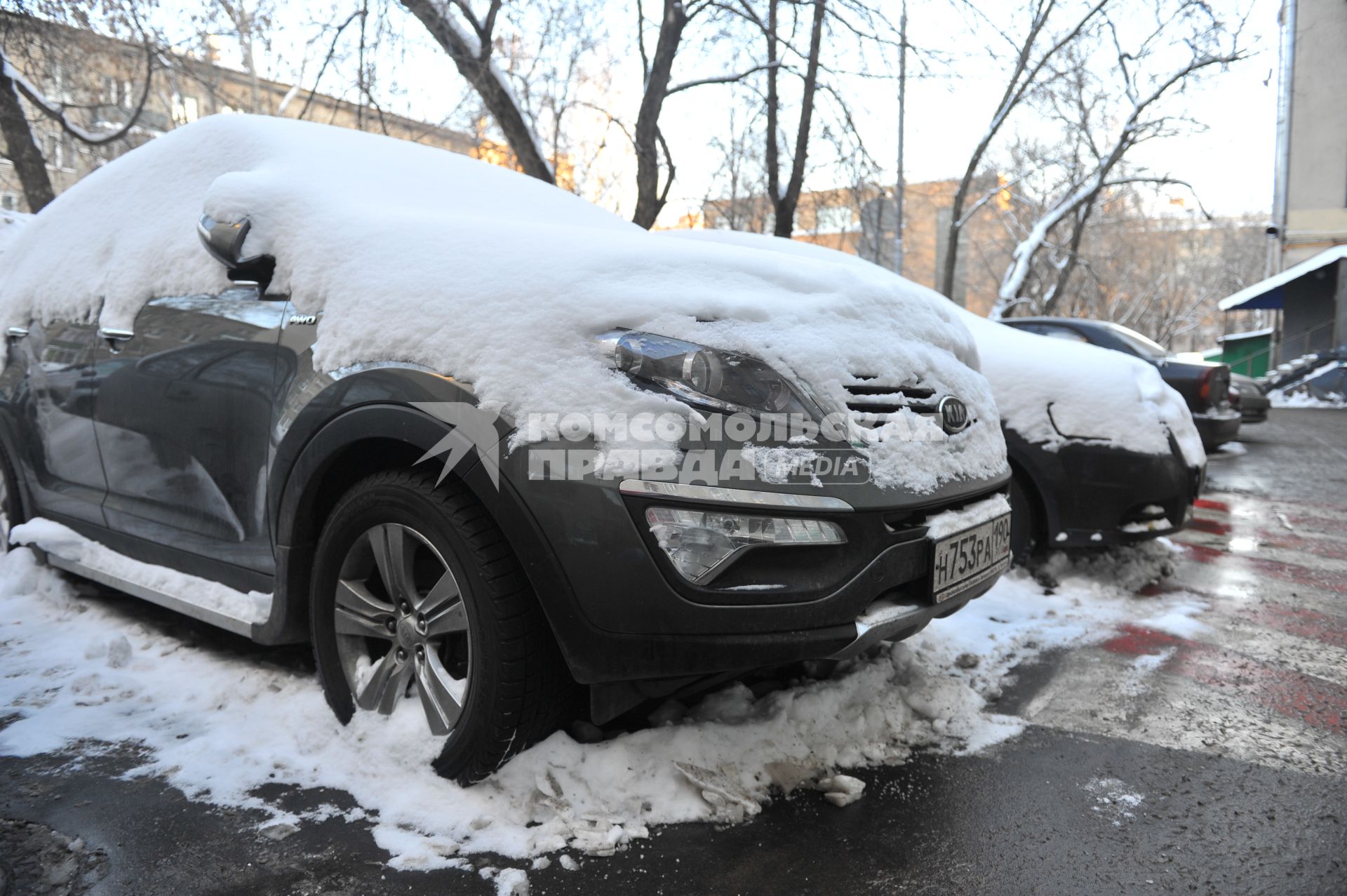 Припаркованные автомобили во дворе дома.