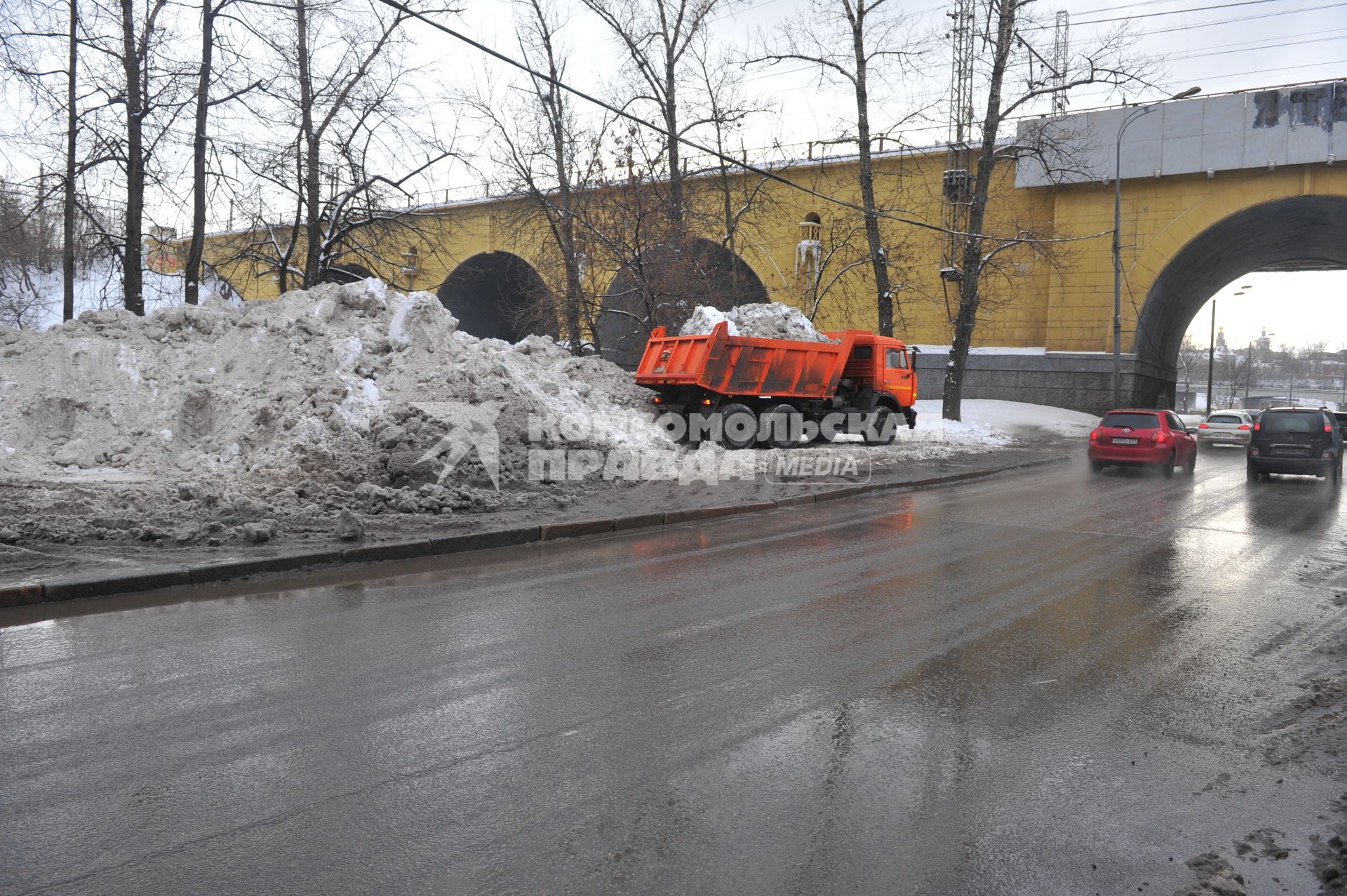 КАМАЗ отгружает снег.