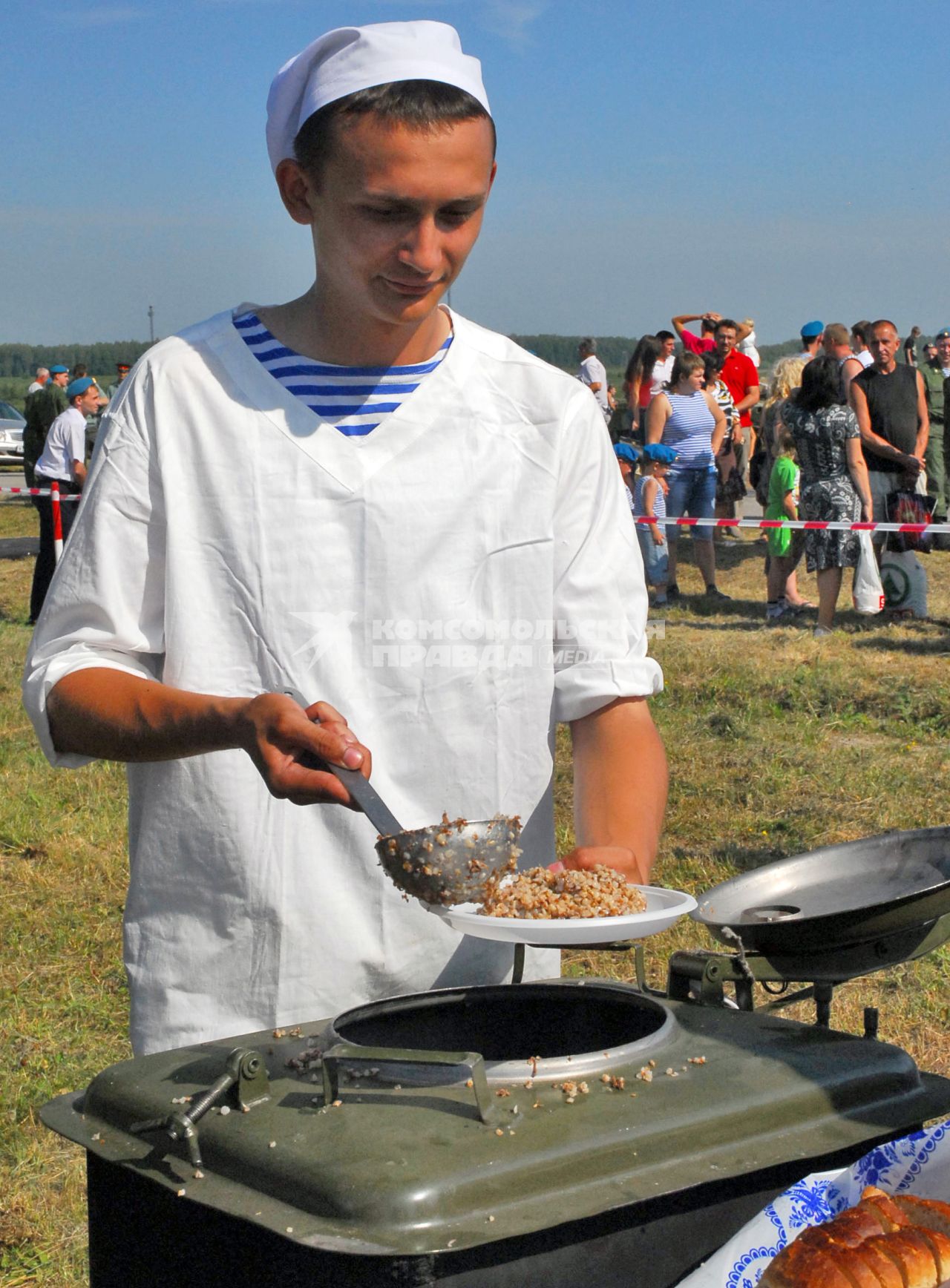 День ВДВ. На снимке: армейский повар накладывает гречку с мясом из походной кухни.