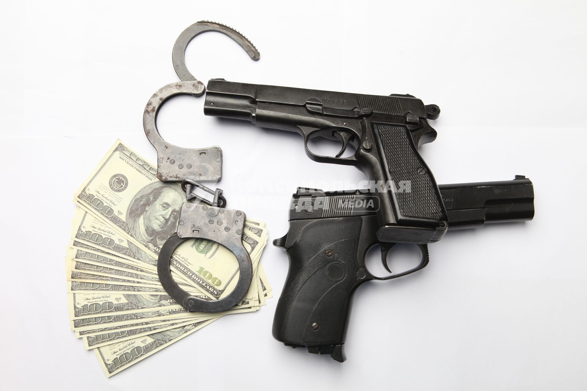 Пистолеты наручники и деньги.