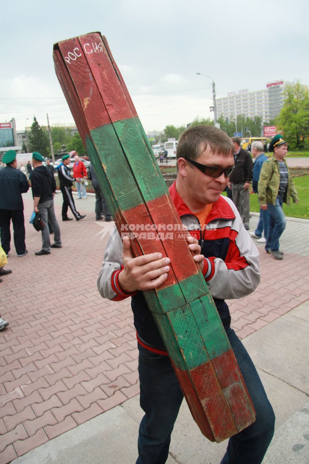 День пограничника. Мужчина несет пограничный столб.