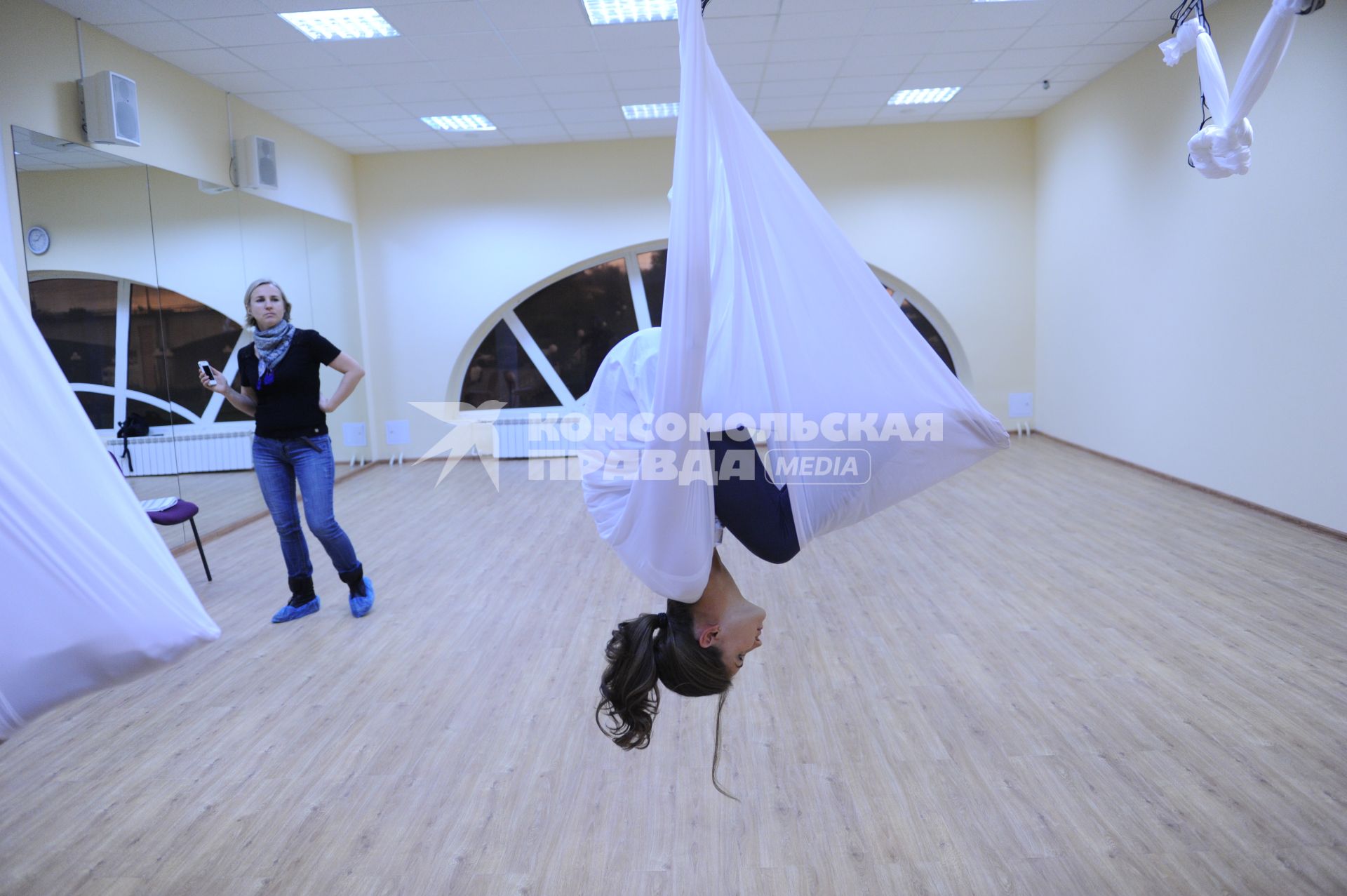 Антигравити Йога (AntiGravity Yoga). Телеведущая Ирина Шадрина (справа) в спортзале.