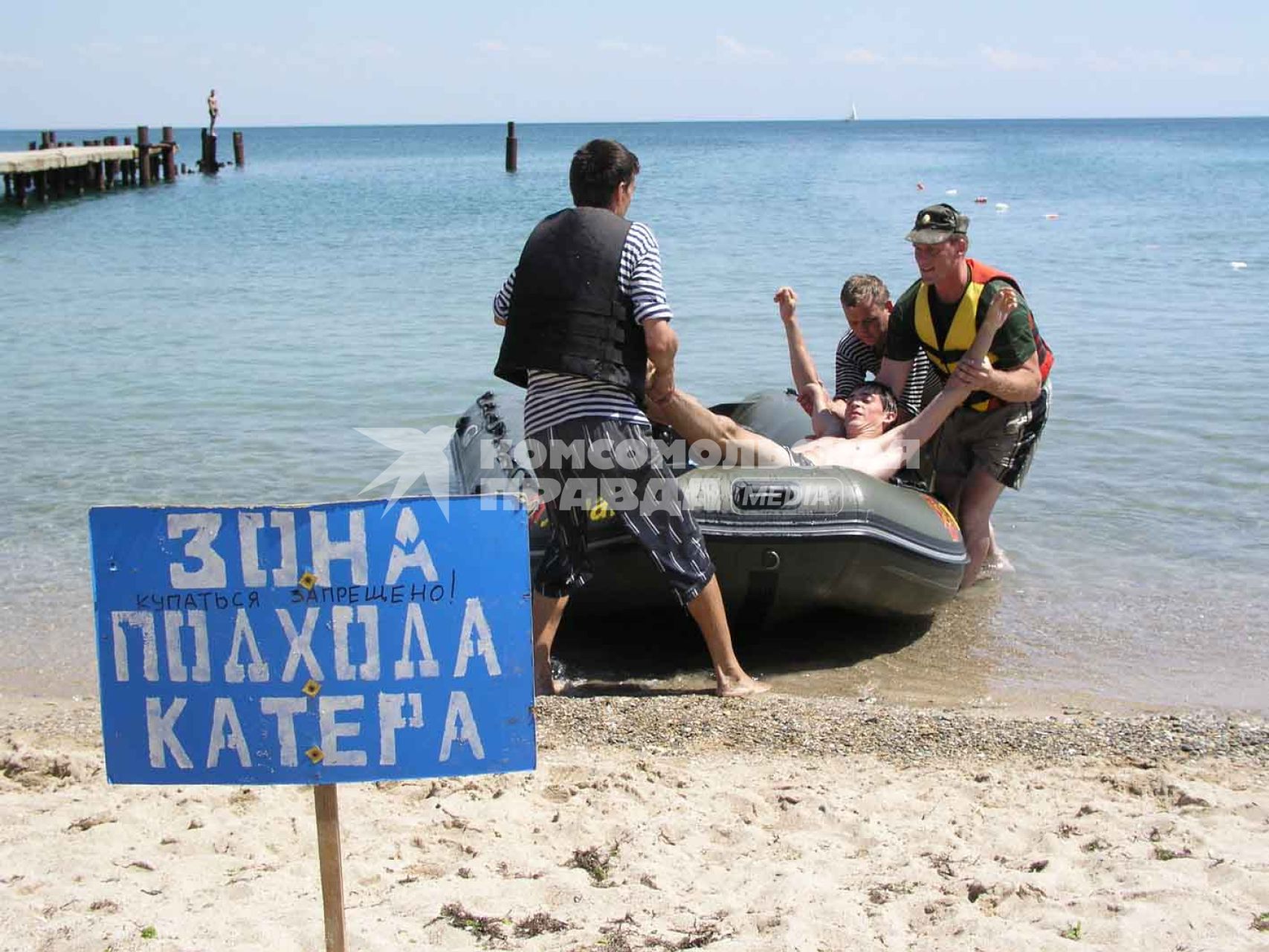 Отдых в Крыму. Спасательная станция. На снимке: спасатели вытаскивают мужчину из катера.