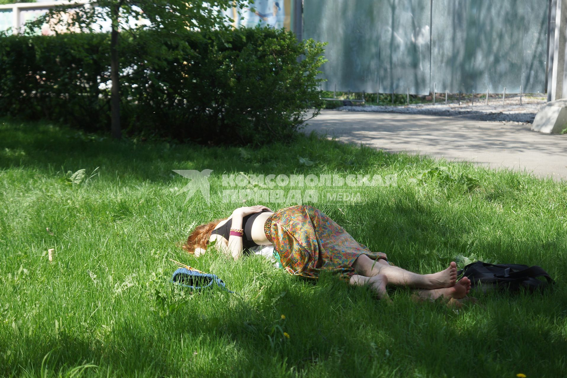 Девушка лежит на парне на газоне в парке