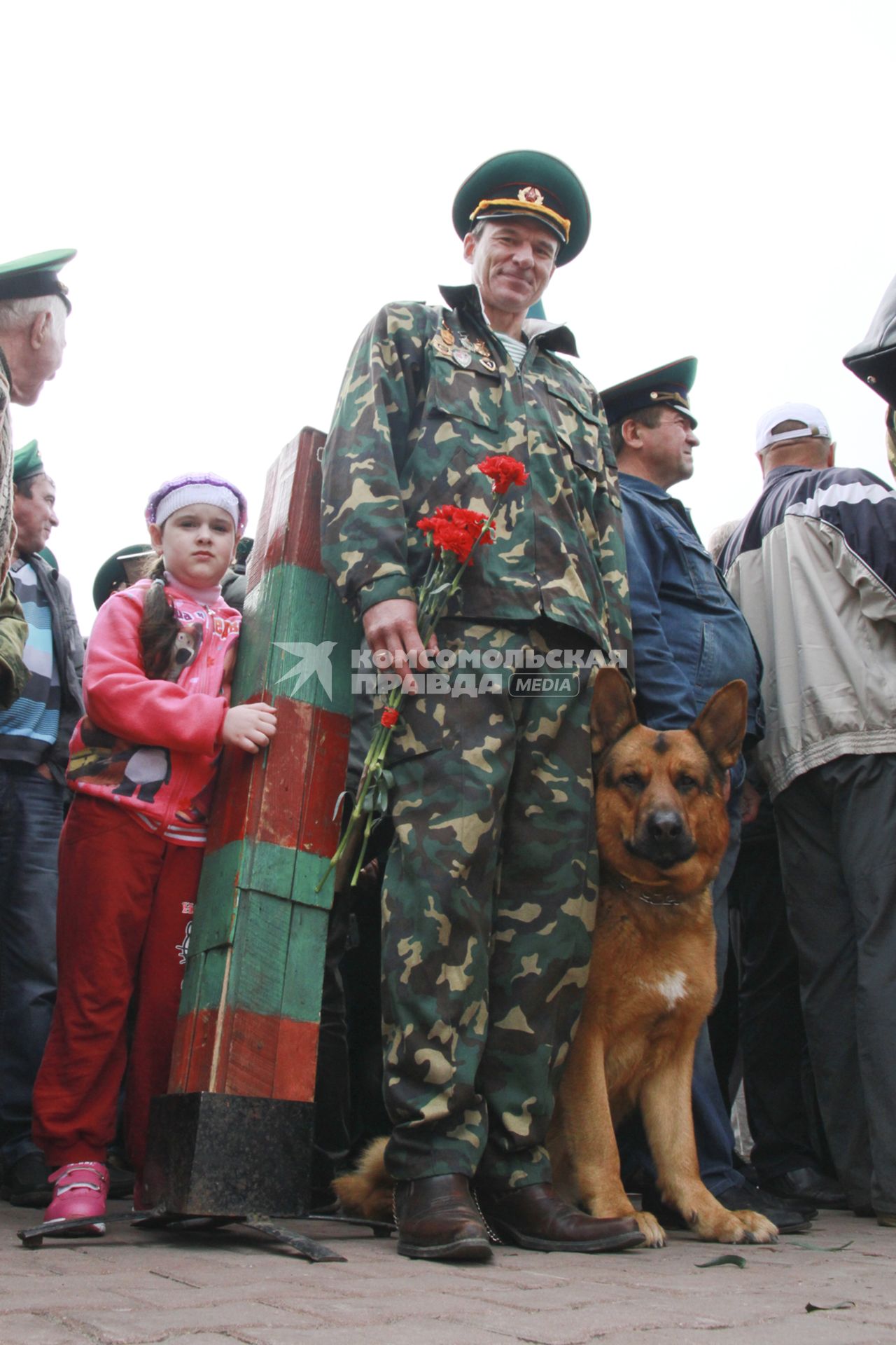 День пограничника в Барнауле. Пограничник с собакой у пограничного столба.