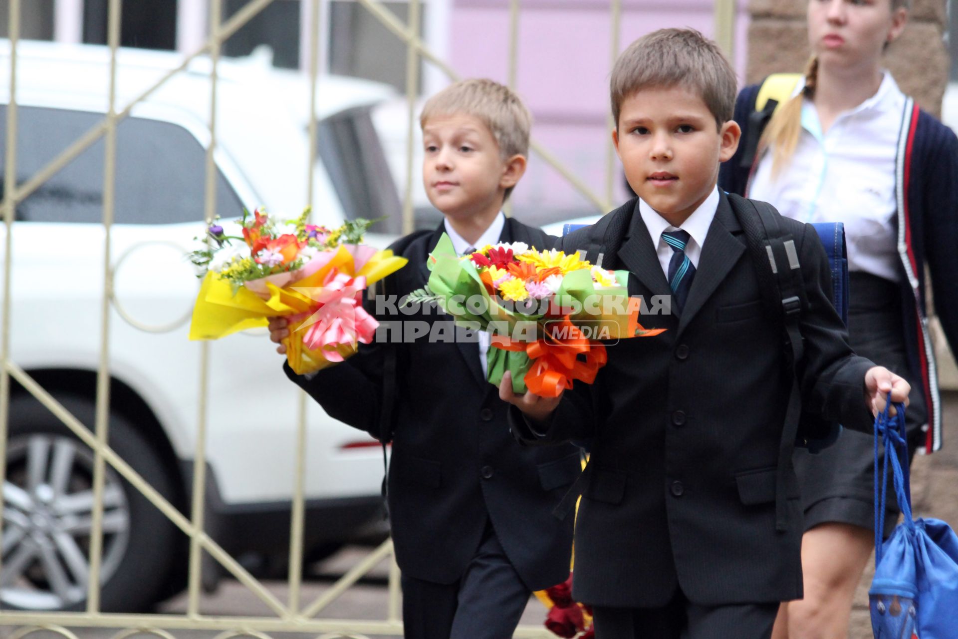 Дети идут в школу с букетами цветов.