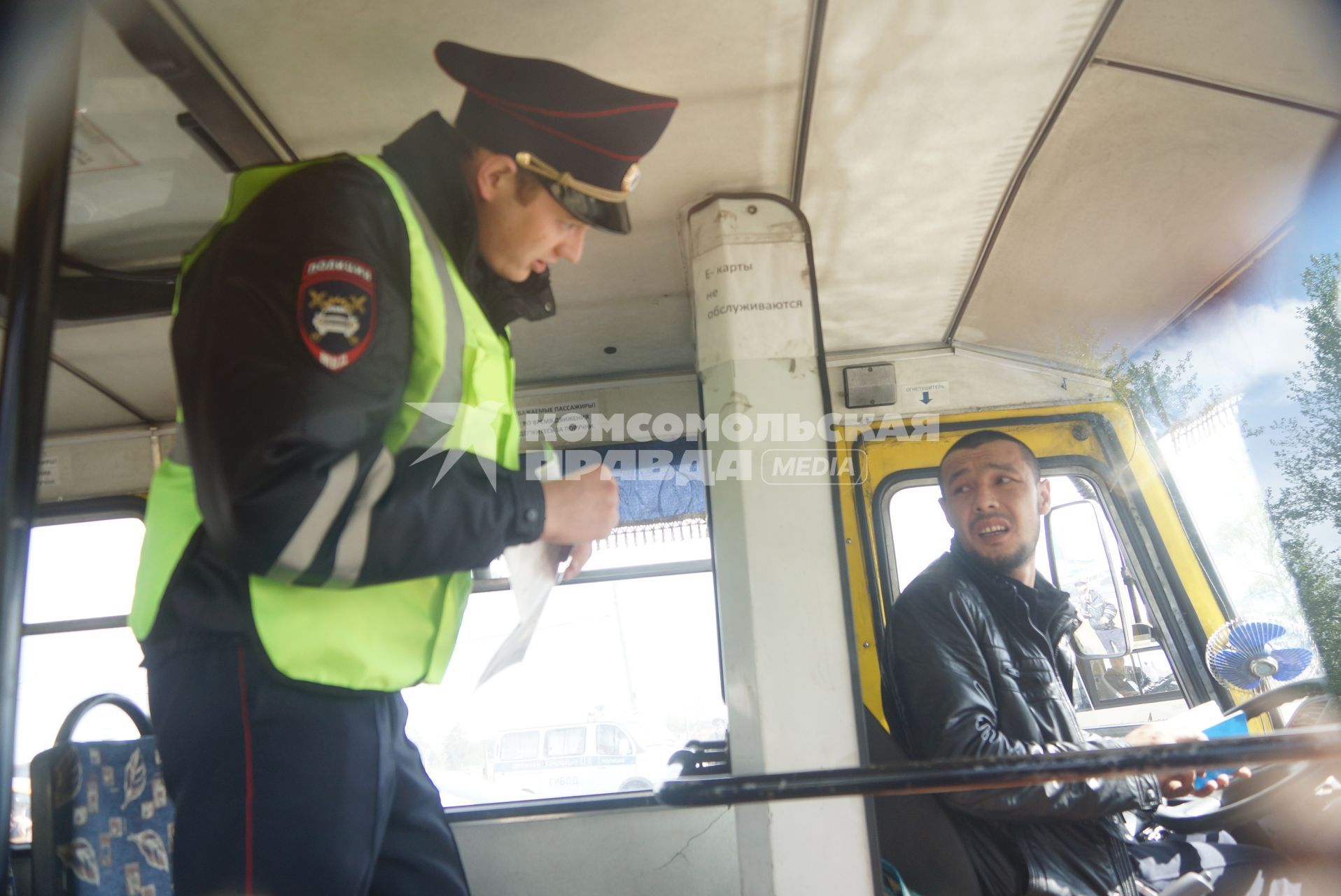 Полицейские ГИБДД проверяед документы у водителя маршрутного автобуса, во время рейда по выявлению неисправных маршруток. Екатеринбург