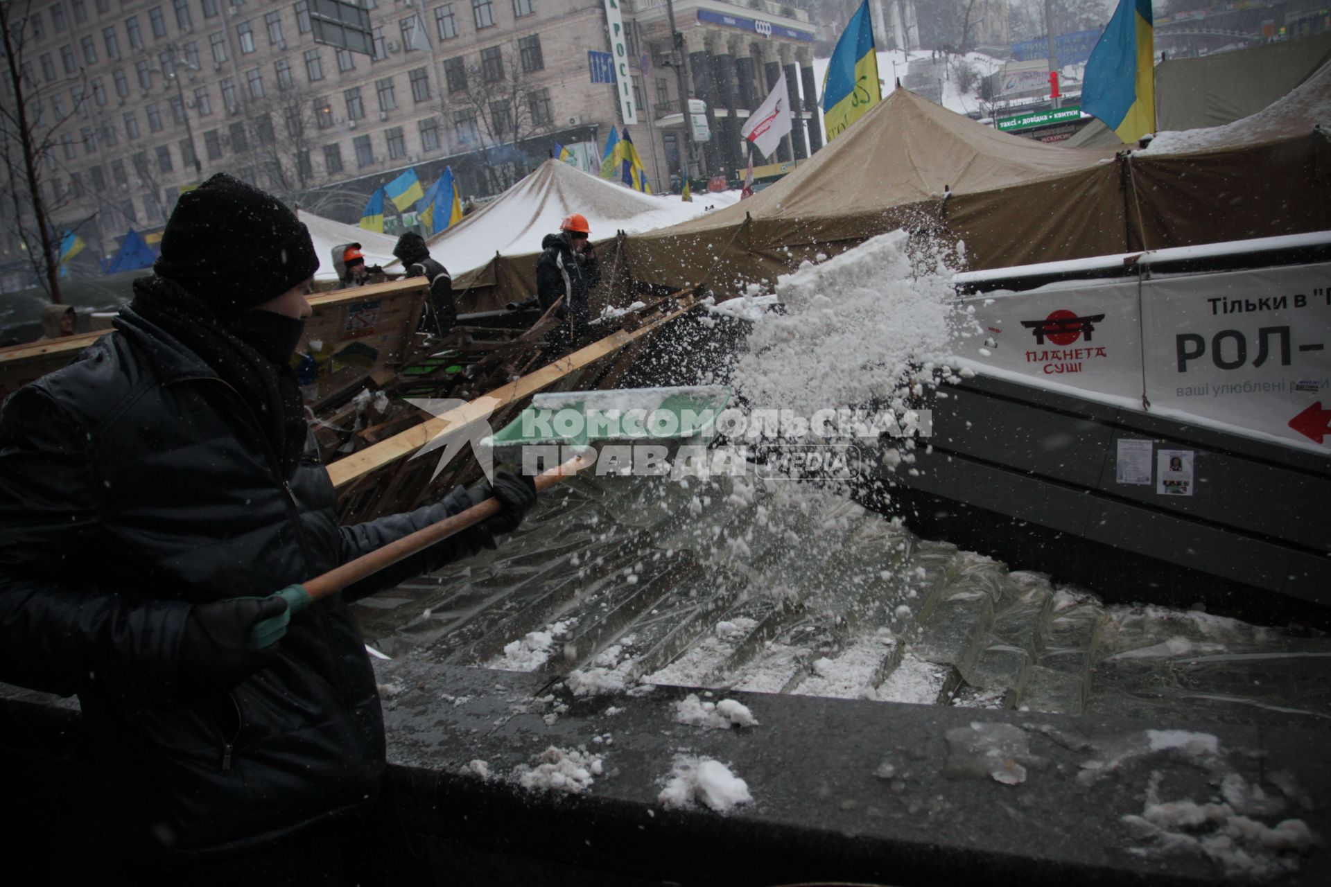 Киев. Евромайдан. Активист убирает снег и скидывает в подземный переход.
