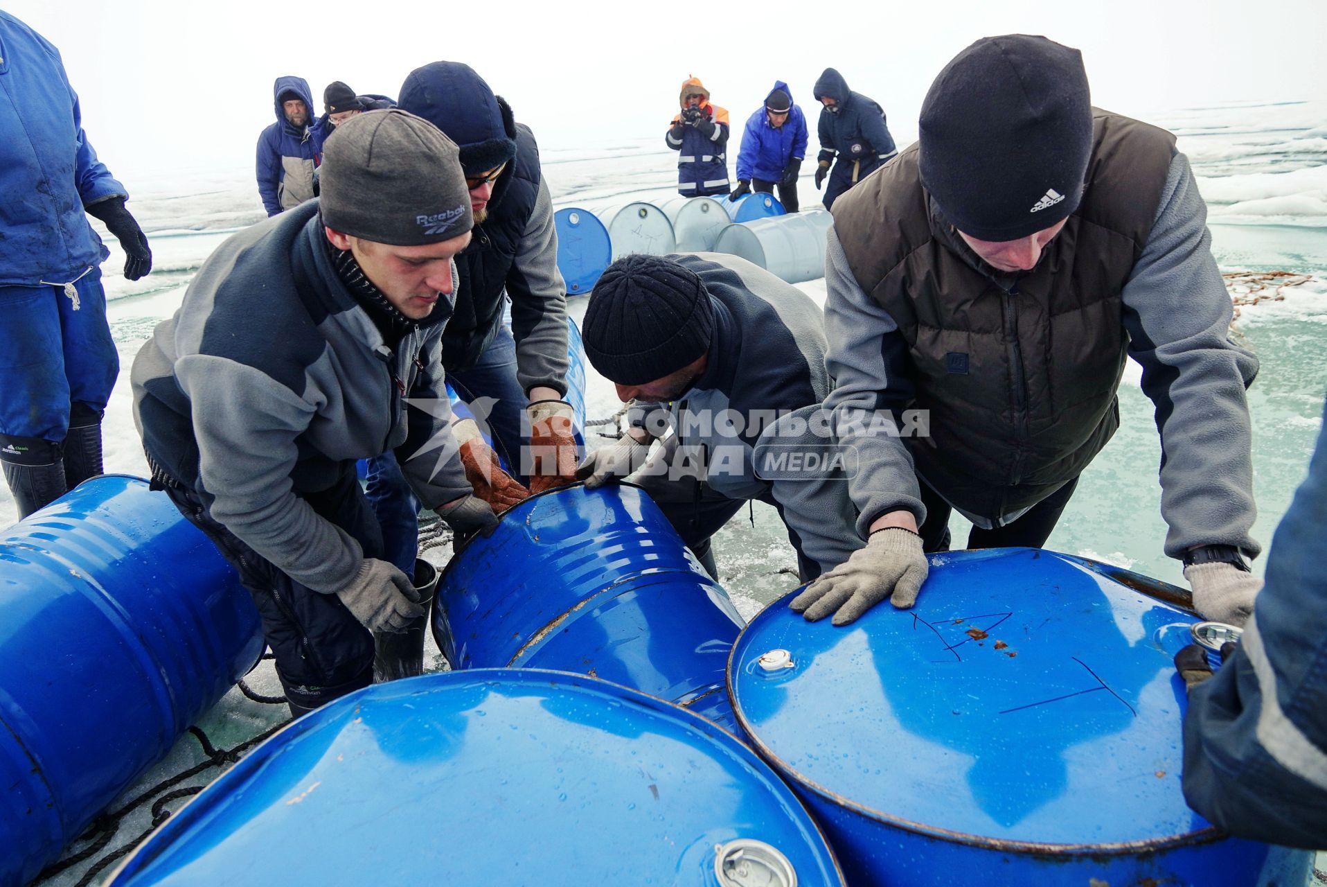 Полярники с сезонной дрейфующей станции \"Северный полюс 2015\" из Арктики, собирают в сеть виние бочки с топливом, для подъема на ледокол \"Капитан Драницын\" перед эвакуацией на большую землю. Северный полюс. Северный ледовитый океан