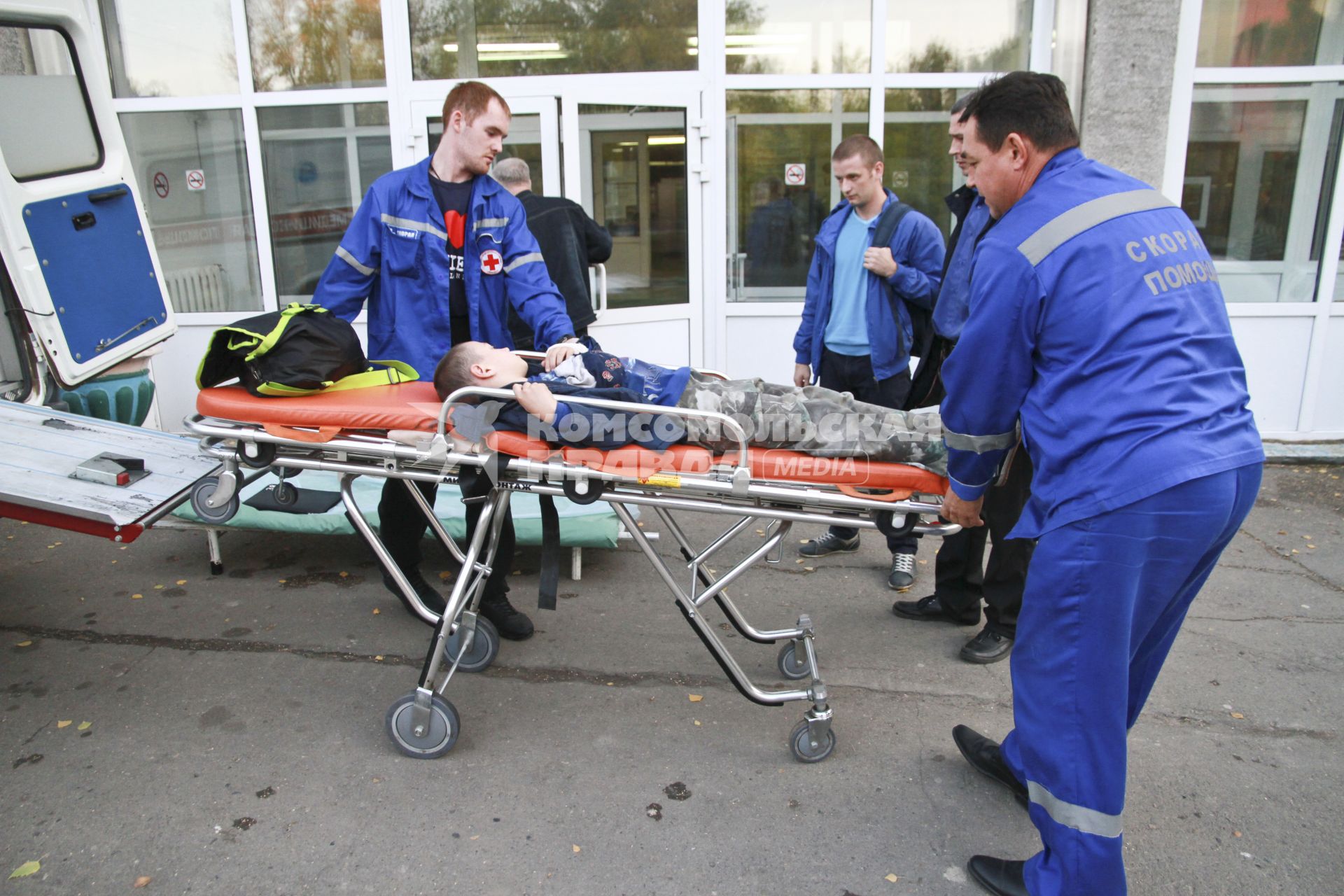 Барнаул. Бригада скорой помощи выгружает носилки с ребенком у приемного покоя.