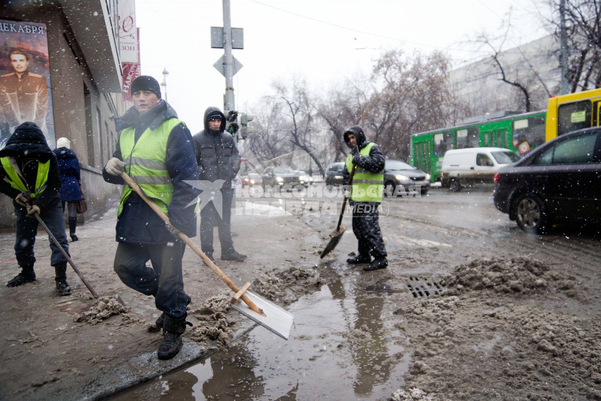 Екатеринбург. Гастарбайтеры убирают лопатами снег с улицы во время снегопада.