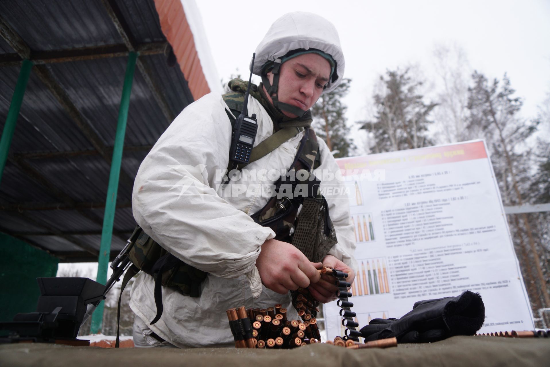 Свердловская область. Адуйский военный полигон. Военнослужащий мотострелковых войск заряжает пулеметную ленту в ходе проверки войск на способность слаженной работы между подразделениями.