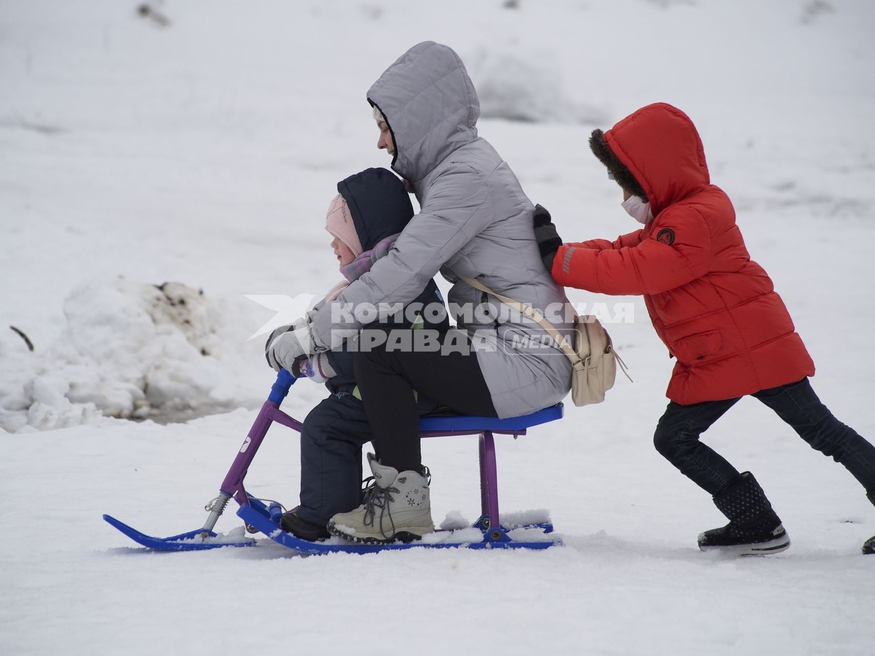 Тула. Женщина с детьми катается на снегокате.