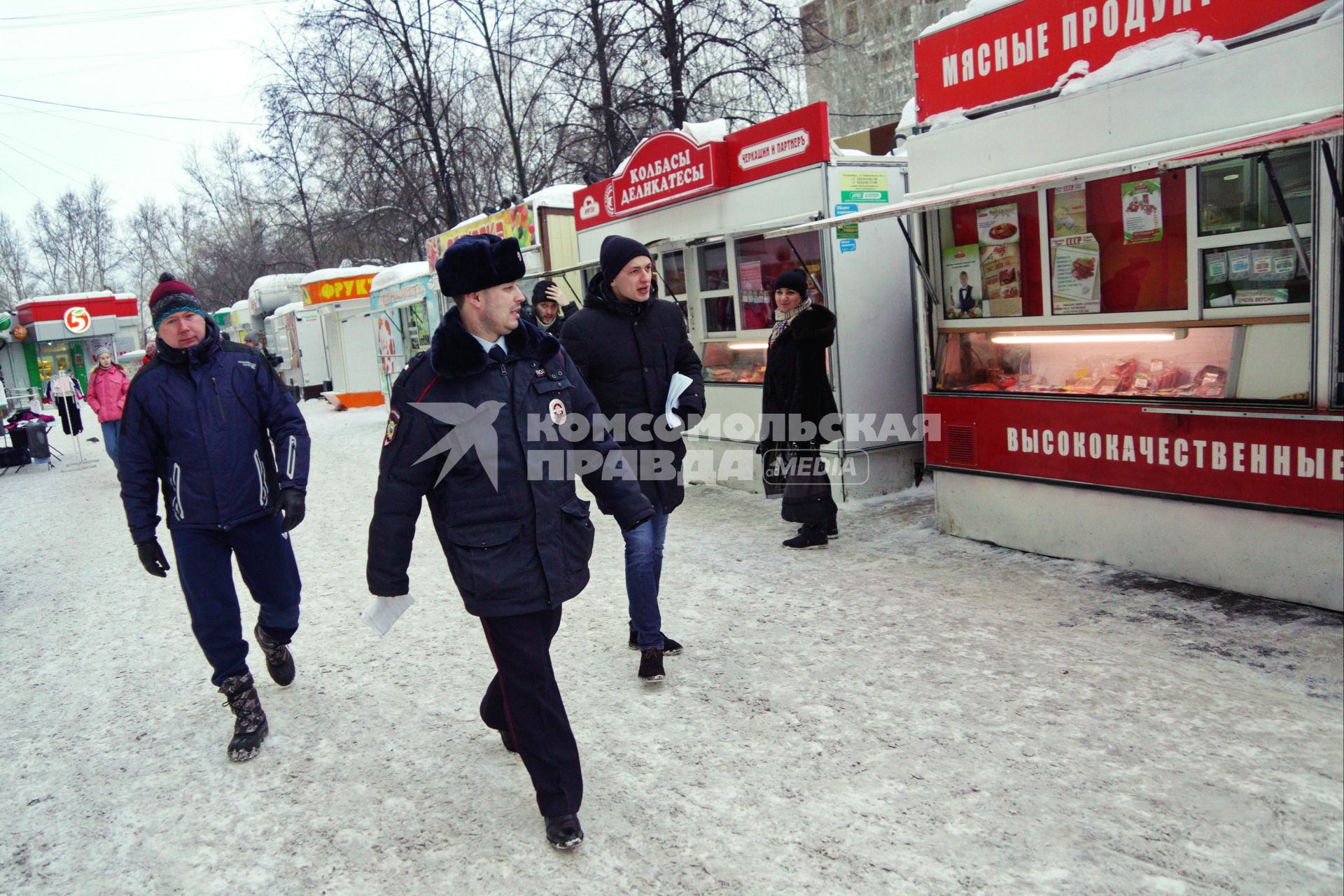 Екатеринбург. Полицейский и сотрудники комитета по товарному рынку во время совместного рейда администрации Екатеринбурга и полиции по пресечению незаконной торговли.