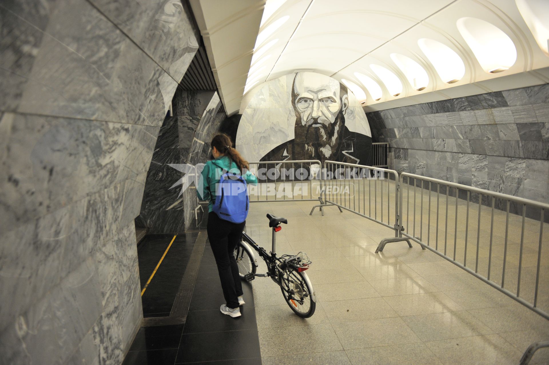 Москва. Девушка с велосипедом  на станции метро `Достоевская`.