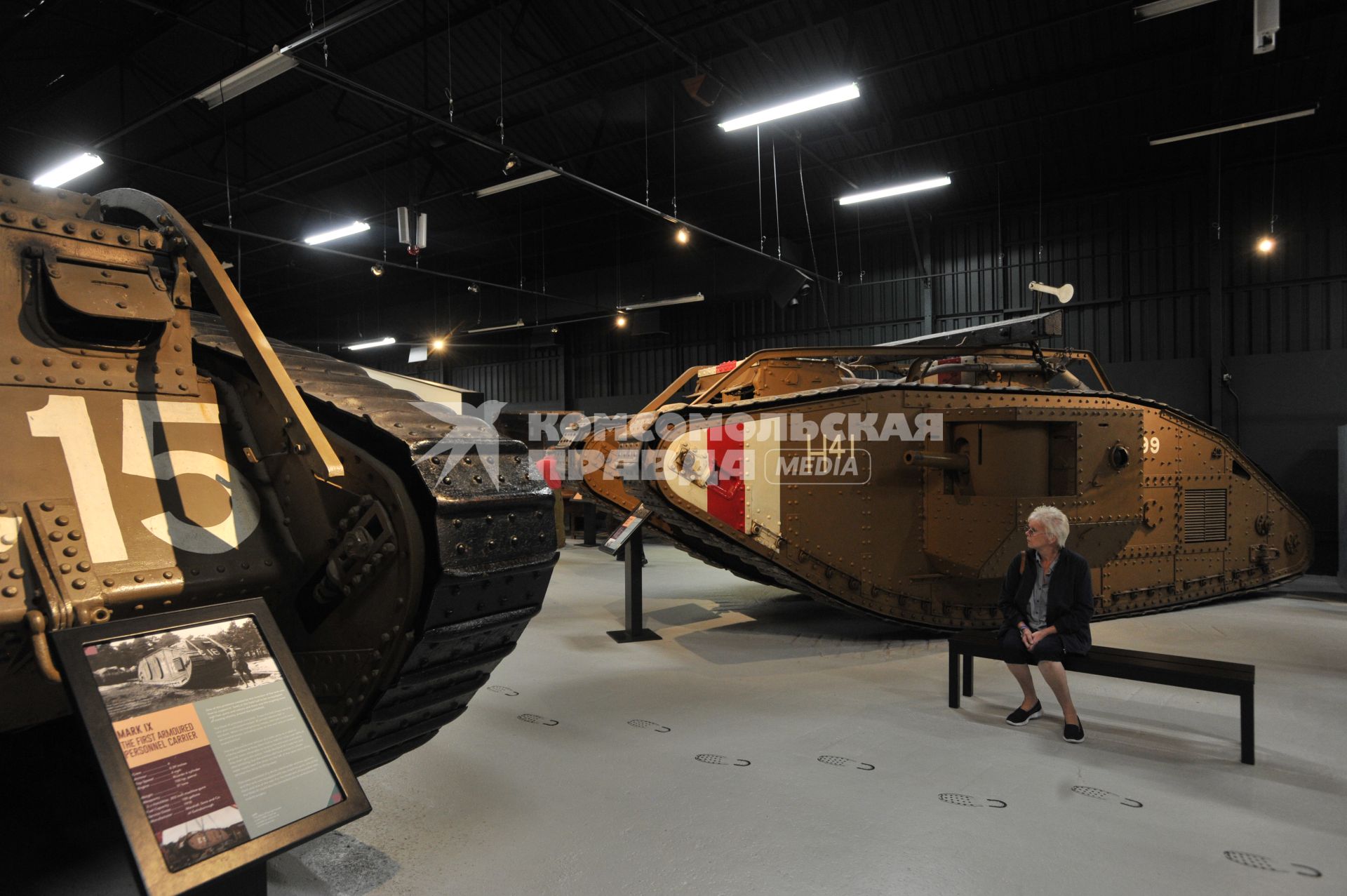 Англия. Лондон. Посетительница в зале среди танков MARK IX  времен  Первой Мировой войны в музее танков в Бовингтоне.