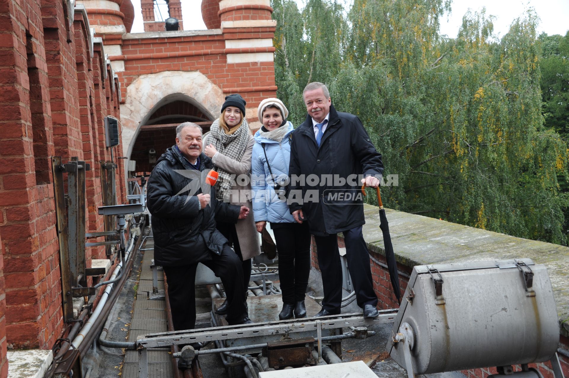 Москва. Корреспонденты `Комсомольской правды` Александр Гамов (слева), Наталия Андреассен (вторая справа), видеоператор Елизавета Совцова (вторая слева) и советник директора ФСО РФ Сергей Девятов на Кремлевской стене.