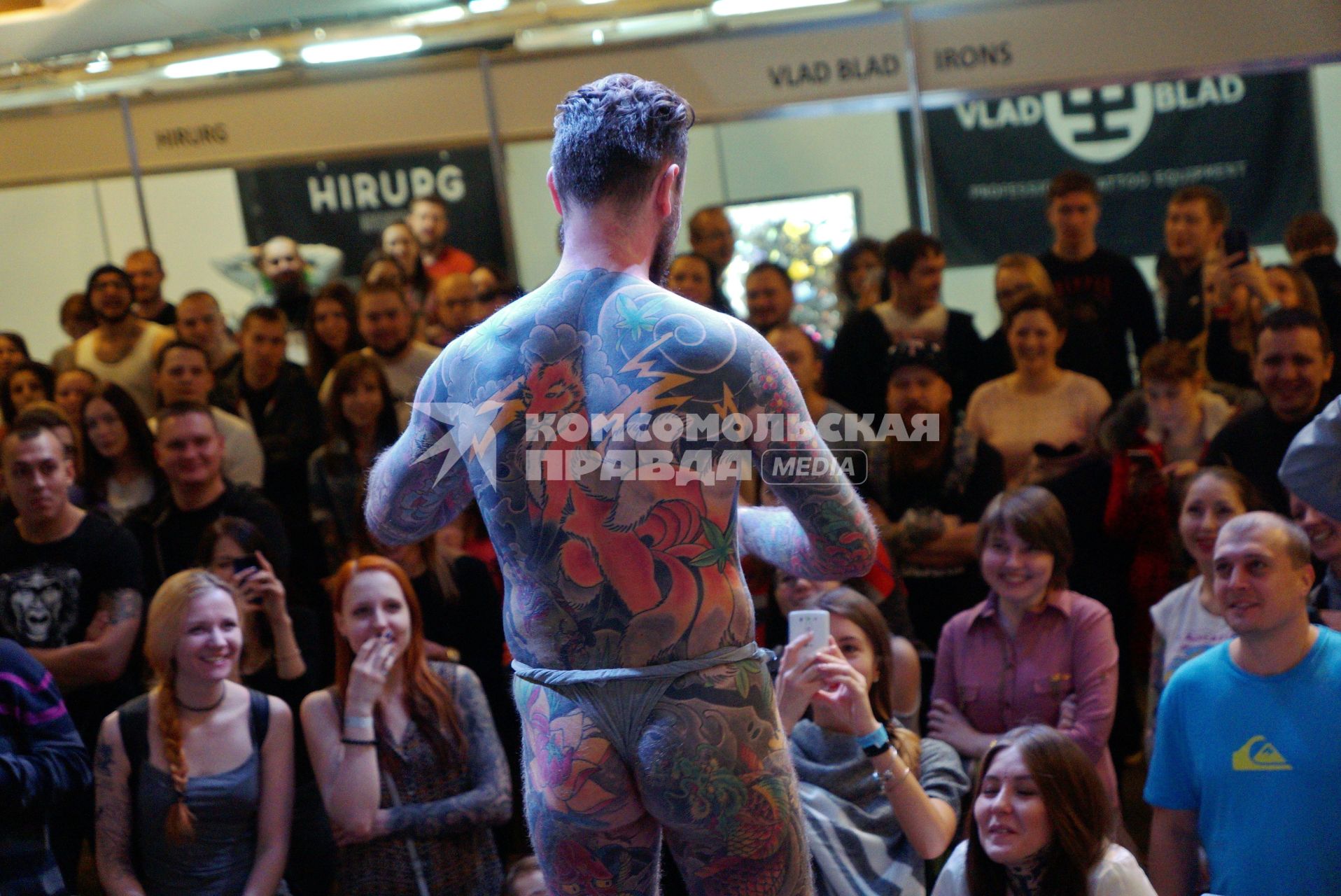 Екатеринбург. Уральский фестиваль искусства татуировки \'Ural tattoo convention 2016\'. Посетители фестиваля фотографирют татуировки конкурсанта покрывающие все его тело