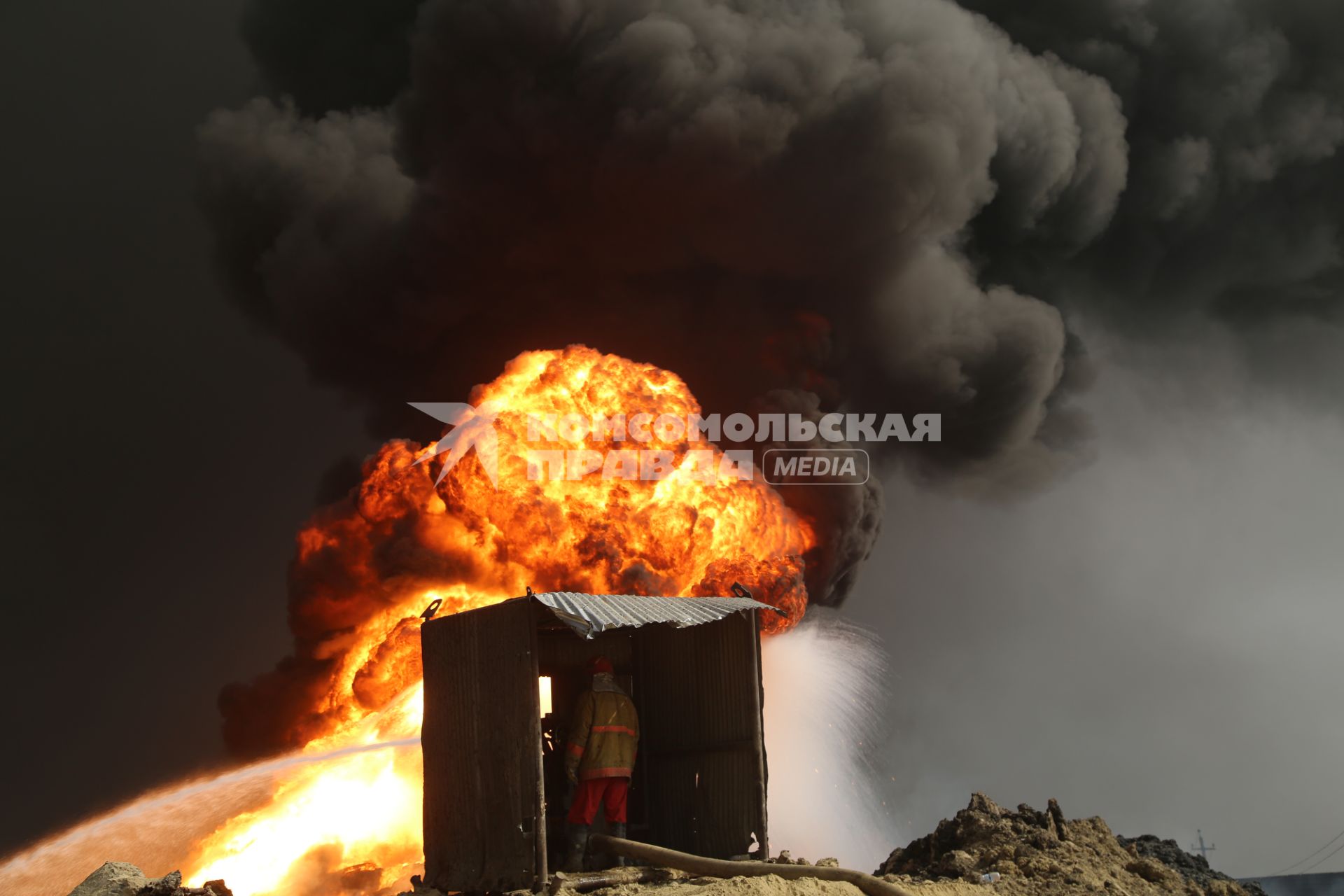 Ирак, Кайара. Пожарные заливают водой горящие нефтяные скважины, подожженные отступающими к Мосулу боевиками `Исламского Государства` (запрещенная в России экстремистская организация).