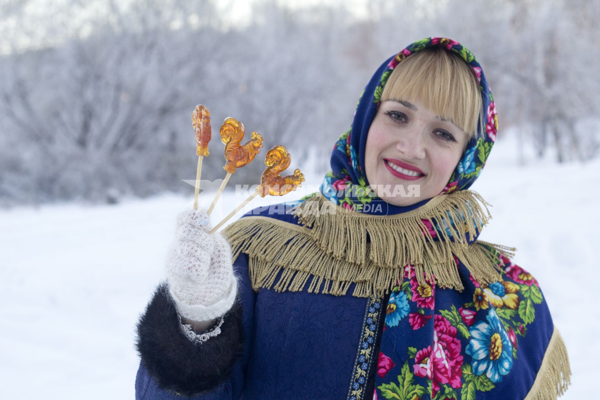 Иркутск. Девушка держит в руке леденцы в форме петушка.