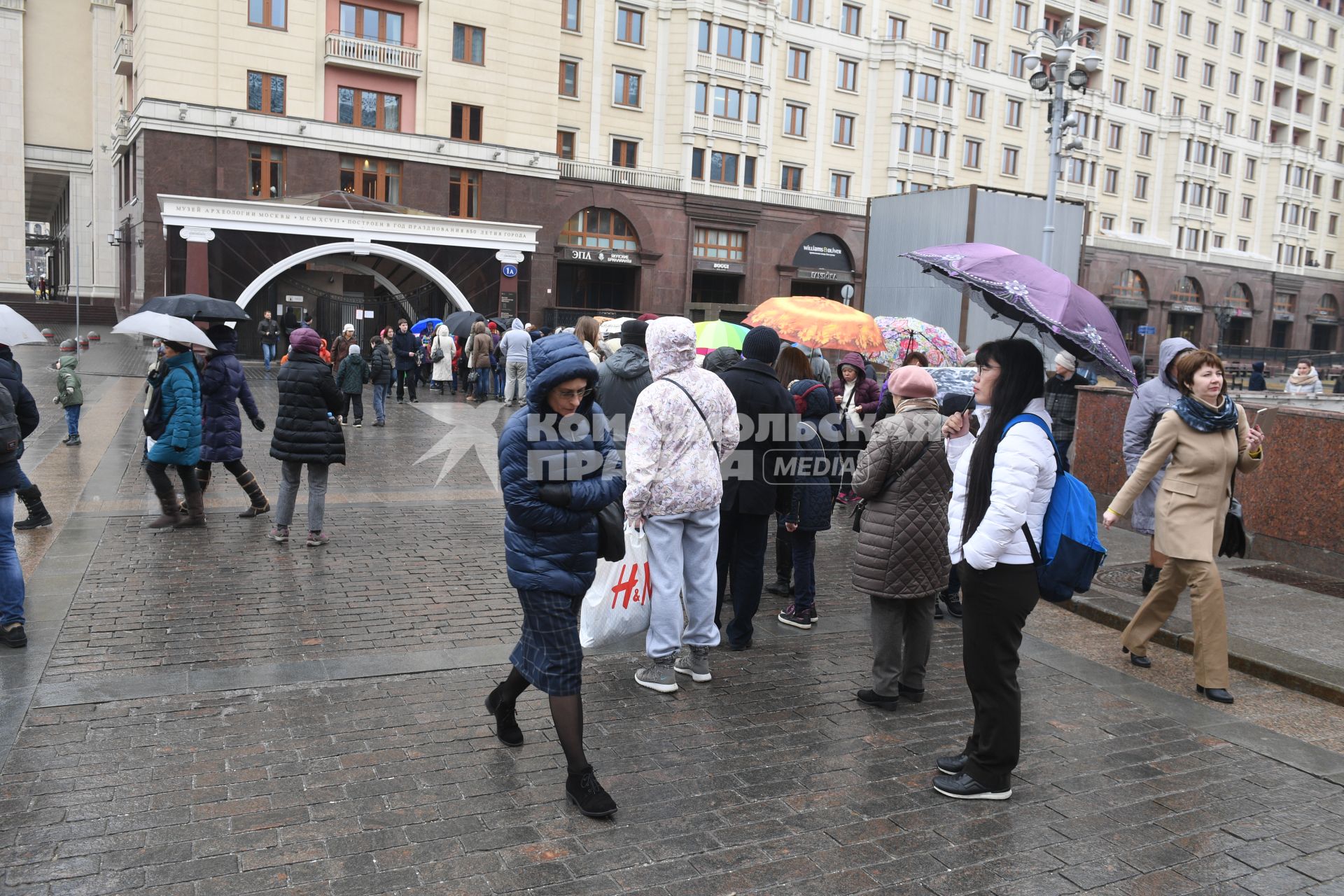 Москва.  Посетители стоят в очереди в музей археологии Москвы на Манежной площади.