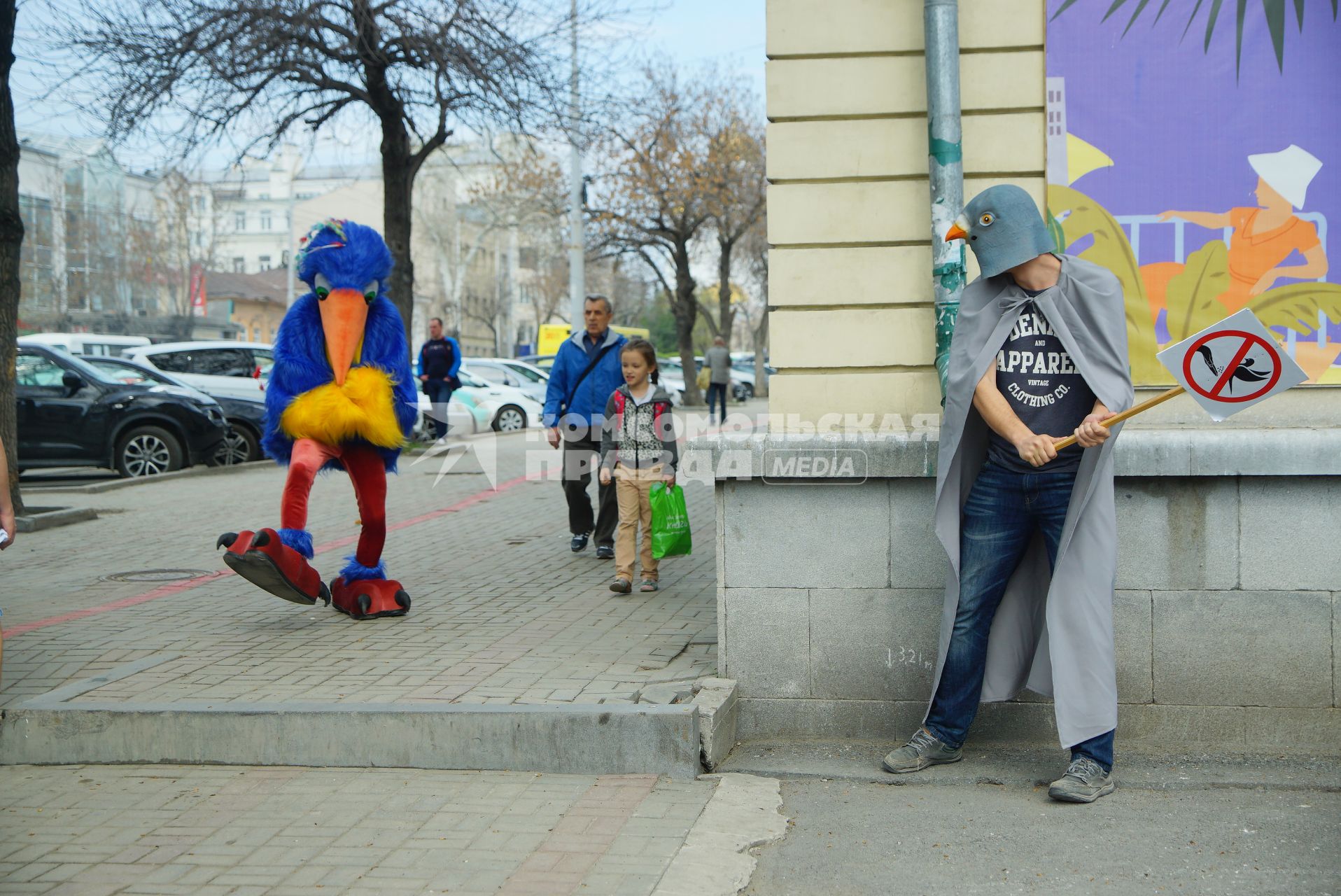 Екатеринбург. \'Человек-антиголубь\' Константин Лескин принятый на работу в музей истории Екатеринбурга для разгона голубей с фасада здания музея, прогоняет человека в костюме птицы крошащего хлеб