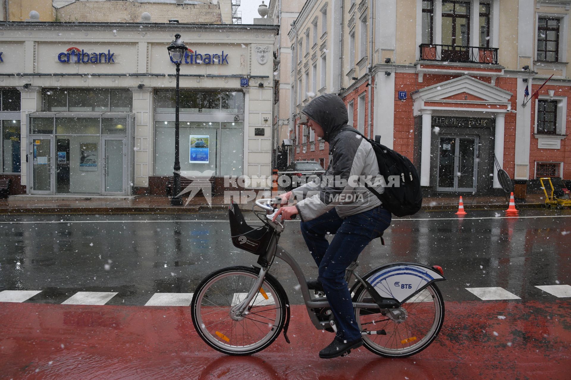 Москва.  Велосипедист под снегом на Большой Никитской улице.