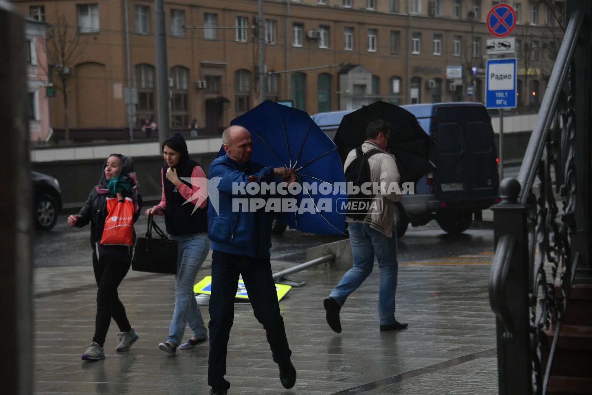 Москва.  Прохожие во время урагана на одной из улиц города.