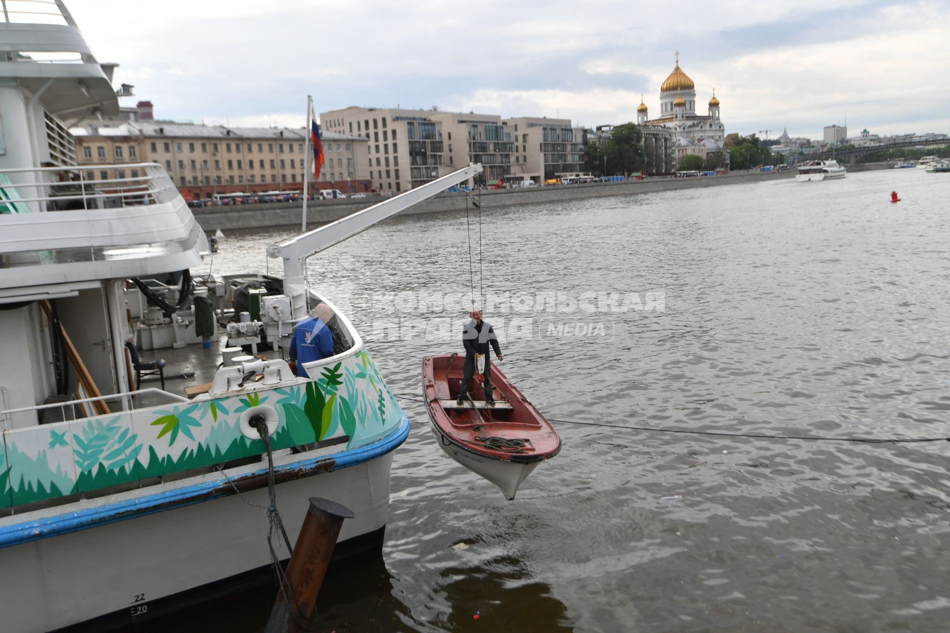 Москва.  Рабочий в лодке  поднимается на борт  теплохода `Валерий Брюсов` , на котором идет демонтаж оборудования.