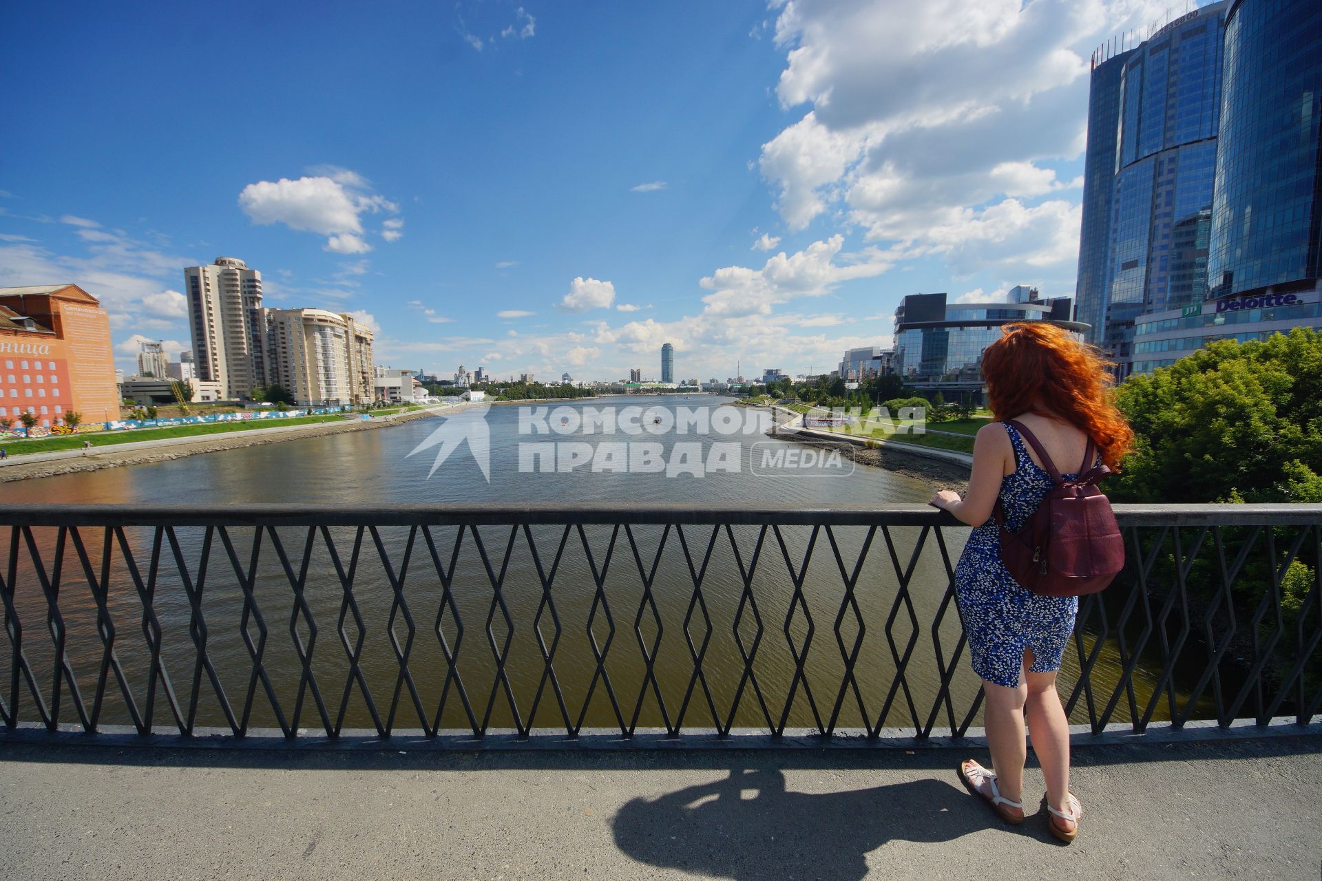 Екатеринбург. Девушка на мосту городского пруда с берегами обмелевшими из-за сброса воды