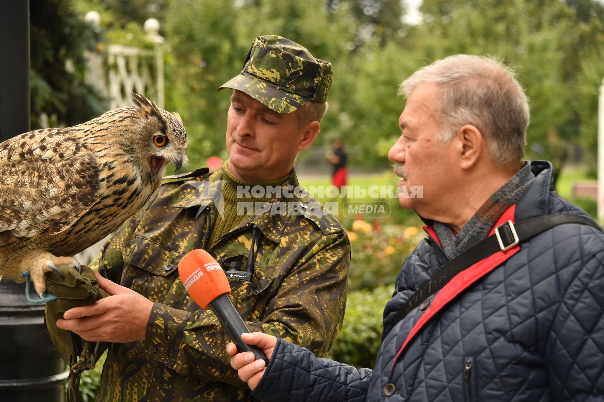 Москва. Корреспондент `Комсомольской правды` Александр Гамов и кремлевский сокольник Алексей Тюрин с филином Филей  на территории  Кремля.