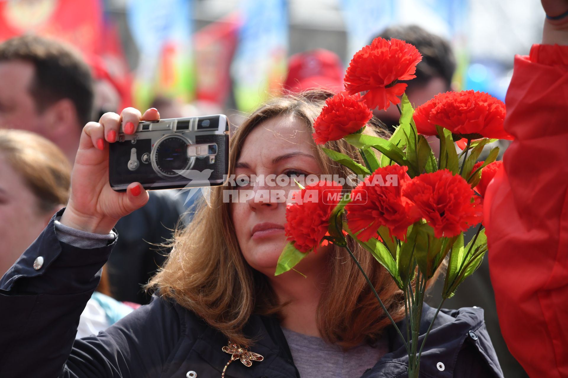 Москва. Женщина фотографирует во время первомайской демонстрации.