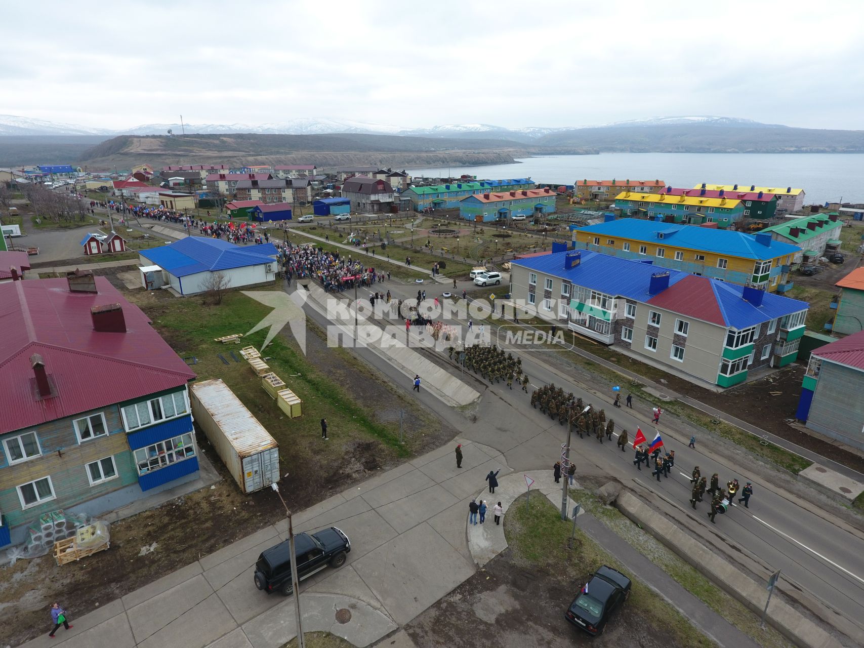 Остров Итуруп, Курильск. Колонна демонстрантов на центральной улице города в день празднования 73-й головщины Победы в Великой Отечественной войне.