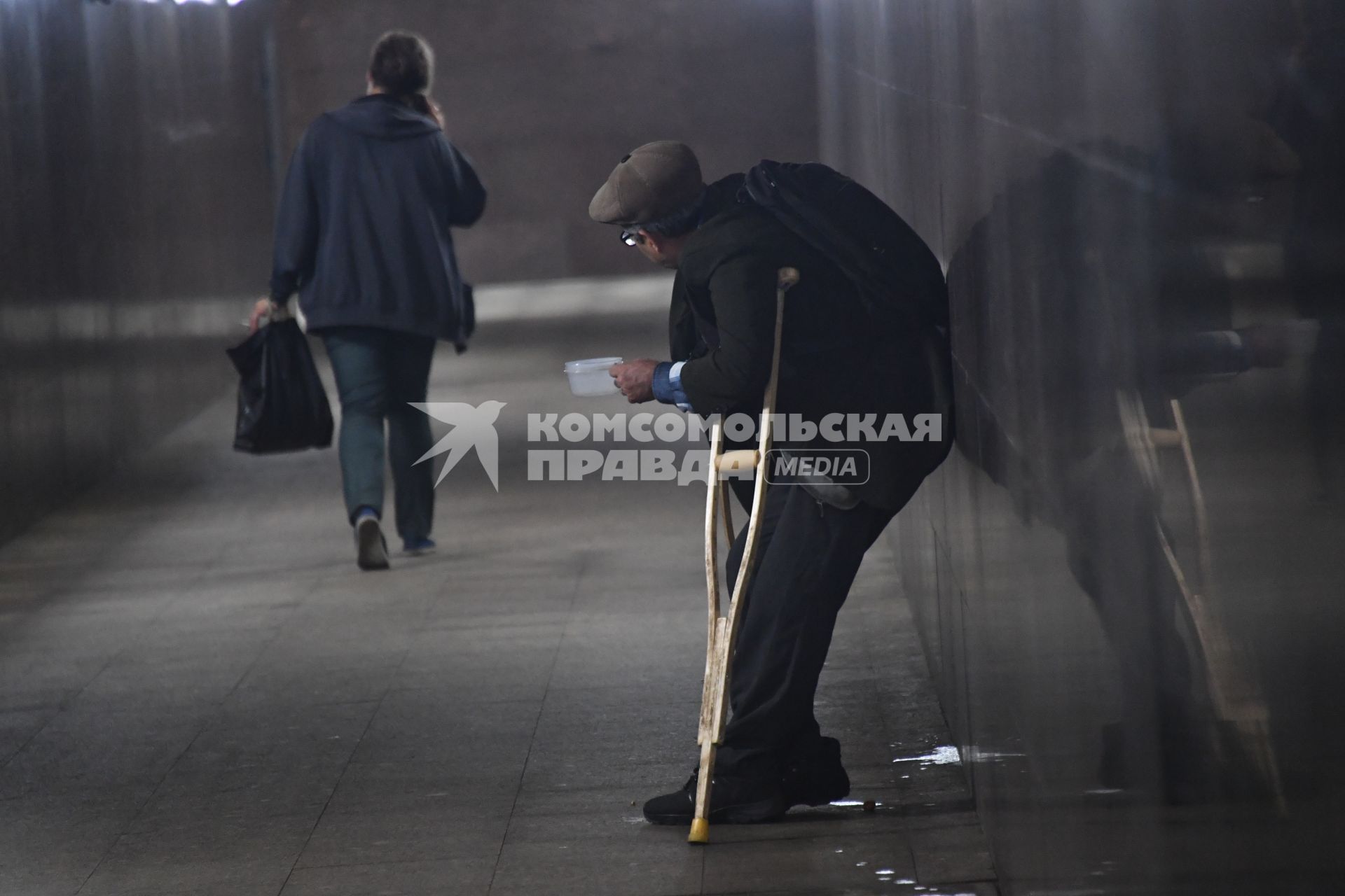 Москва. Мужчина просит милостыню в переходе.