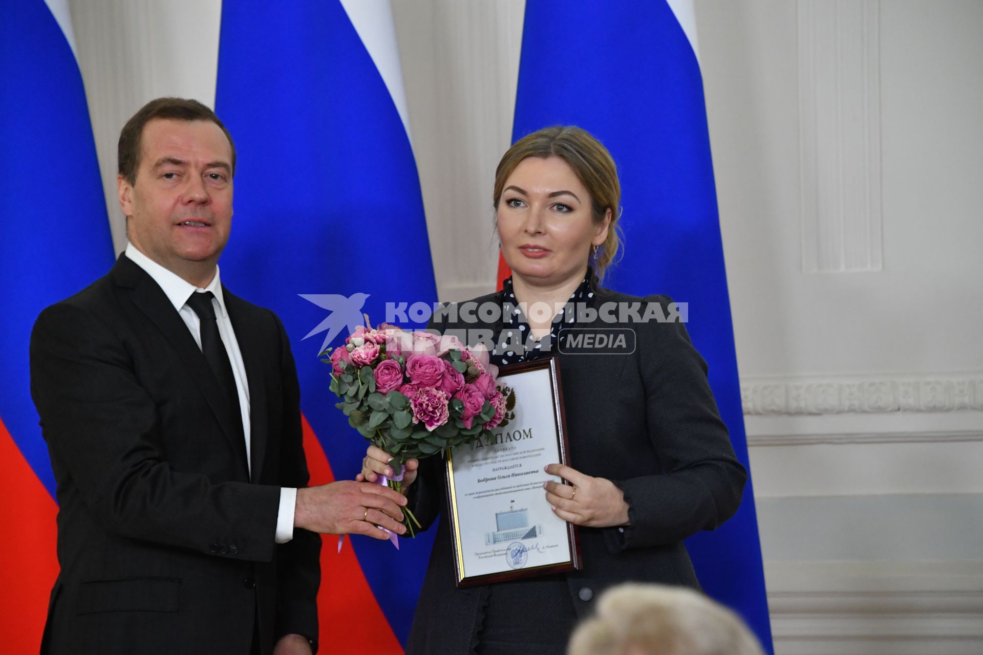 Москва.  Премьер-министр РФ Дмитрий Медведев  и редактор отдела спецрепортажей `Новой газеты` Ольга Боброва во  время церемонии вручения премий правительства  РФ в области СМИ.