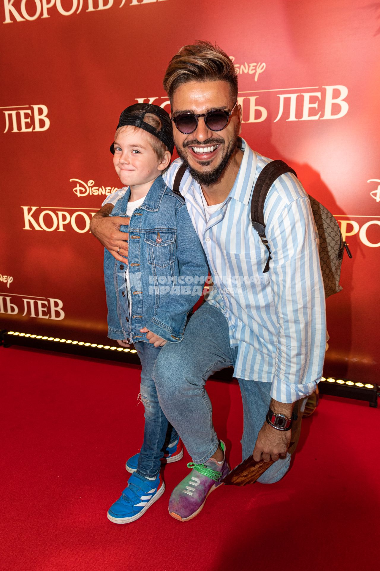 Москва.  Футболист Евгений Савин с сыном  на премьере фильма Disney `Король Лев` в кинотеатре `Каро 11 Октябрь` на Новом Арбате.